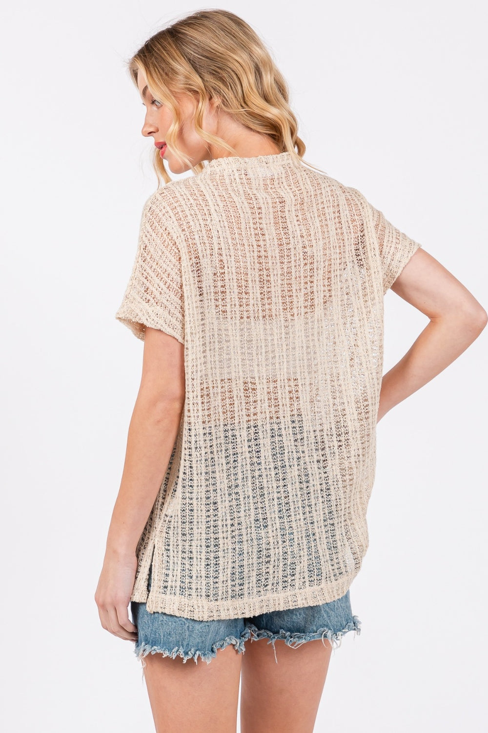 The See Through Crochet Mock Neck Cover Up is a stylish and versatile addition to your wardrobe. Perfect for layering over a swimsuit or pairing with a camisole for a boho-chic look. The intricate crochet detailing adds a touch of texture and visual interest.  S-L