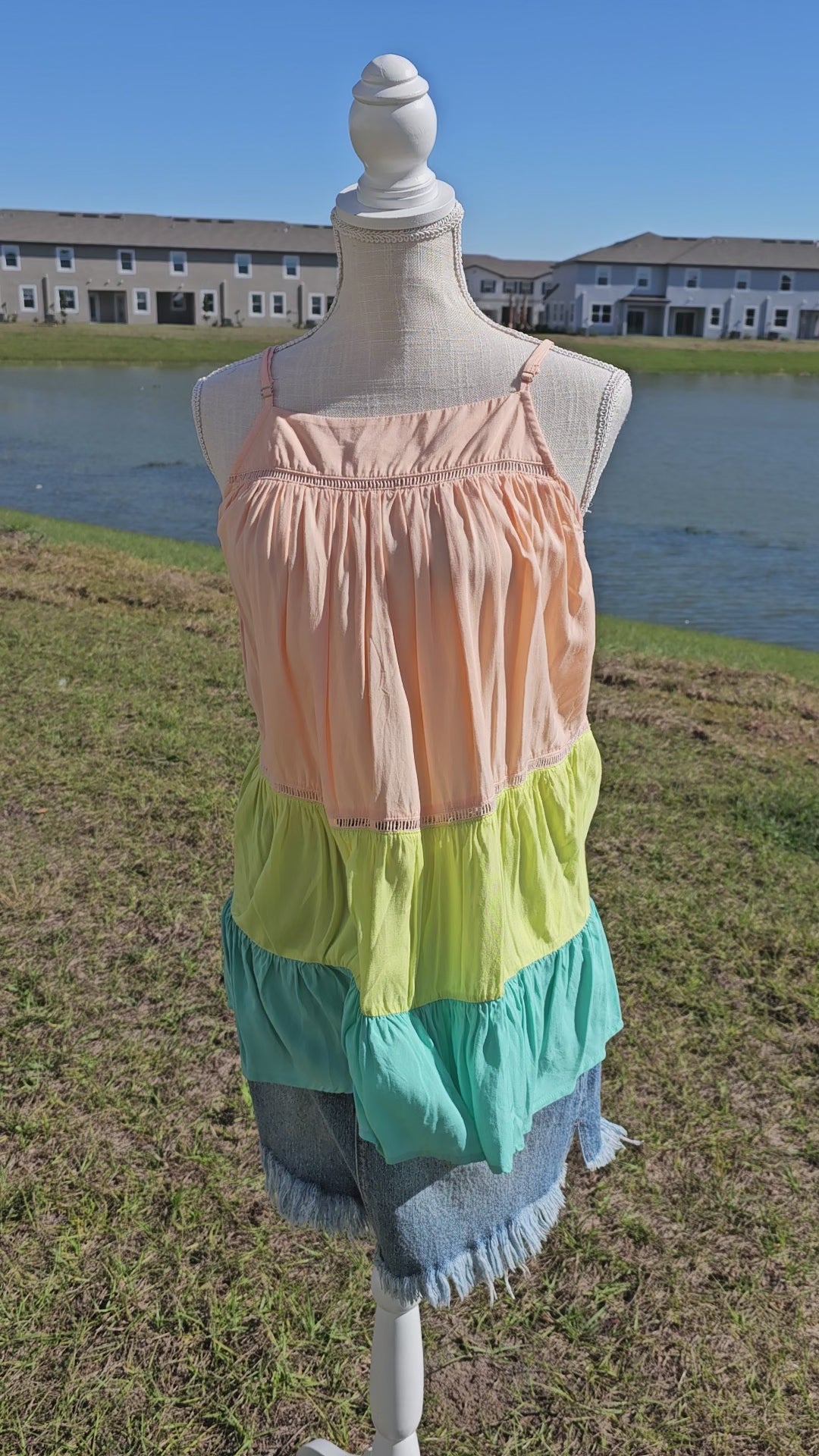 “Tutti Frutti” is a vibrant color block tank top. This tank top features three tiers of color (sherbet orange, lime green, light teal), adjustable straps, elastic back, pleated flare top and cute peekaboo lace trim. This top does not have stretch, but is loose fitting and longer in length. It is super lightweight and breathable. Sizes small through large.