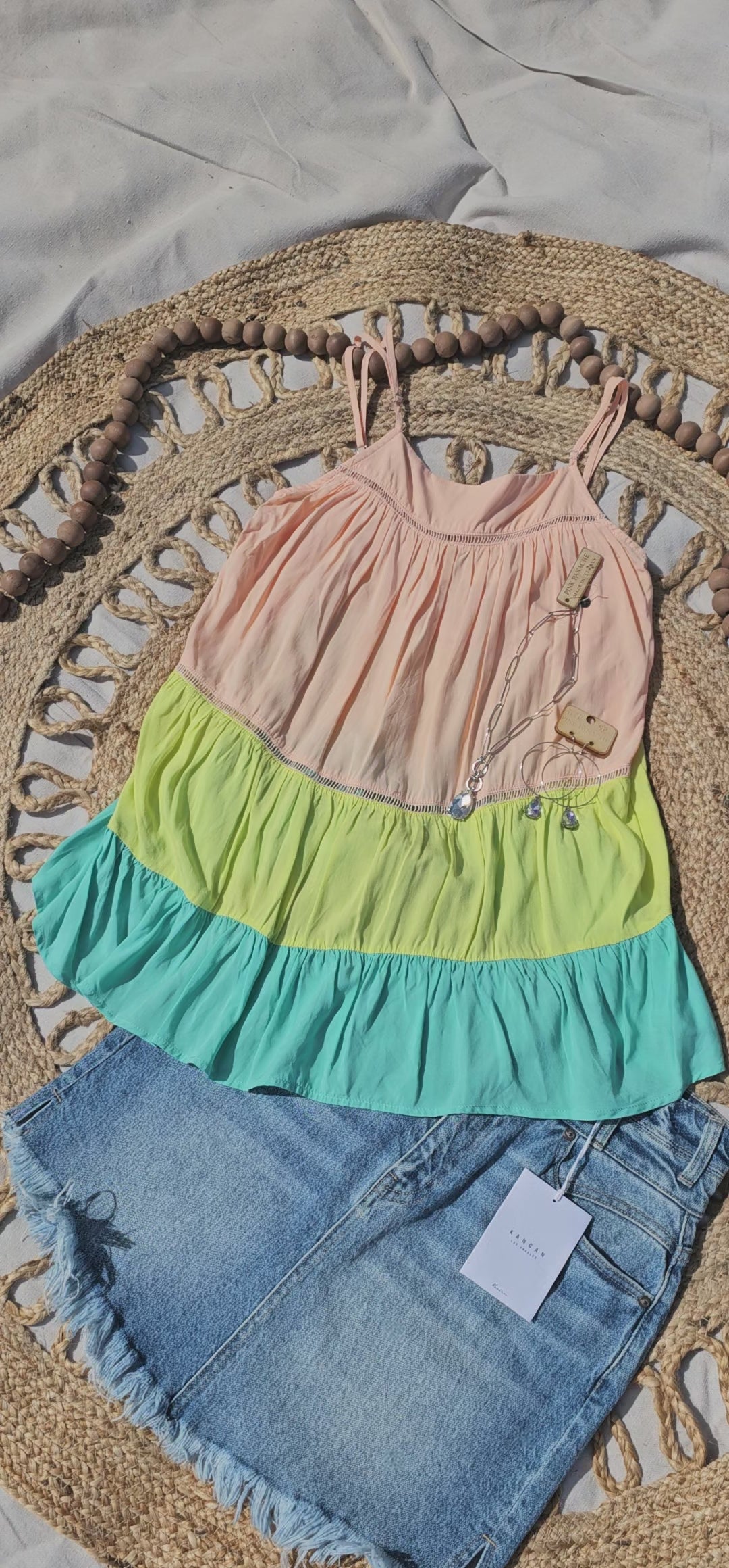 “Tutti Frutti” is a vibrant color block tank top. This tank top features three tiers of color (sherbet orange, lime green, light teal), adjustable straps, elastic back, pleated flare top and cute peekaboo lace trim. This top does not have stretch, but is loose fitting and longer in length. It is super lightweight and breathable. Sizes small through large.