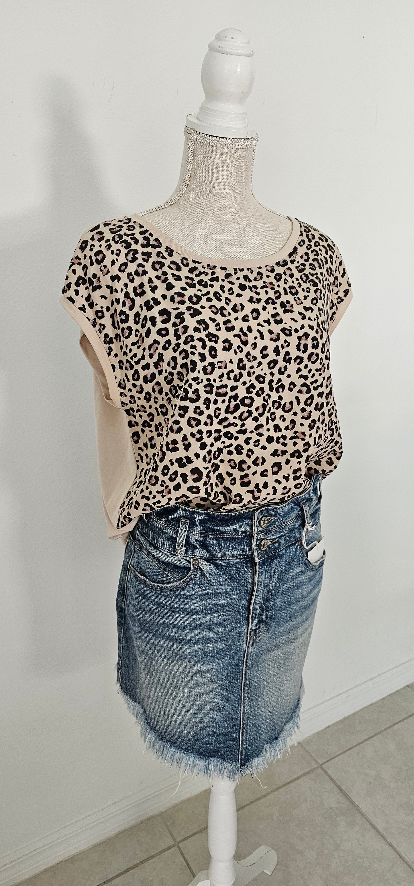 “Road Less Traveled” is a sleeveless top, with leopard print front (beige, brown, camel, agreeable gray) and contrast back, boat neckline, trimmed with beige soft modal, and rounded hemline. This is a satiny, silky soft high-low top. This is definitely a business or casual top. Sizes small through large.
