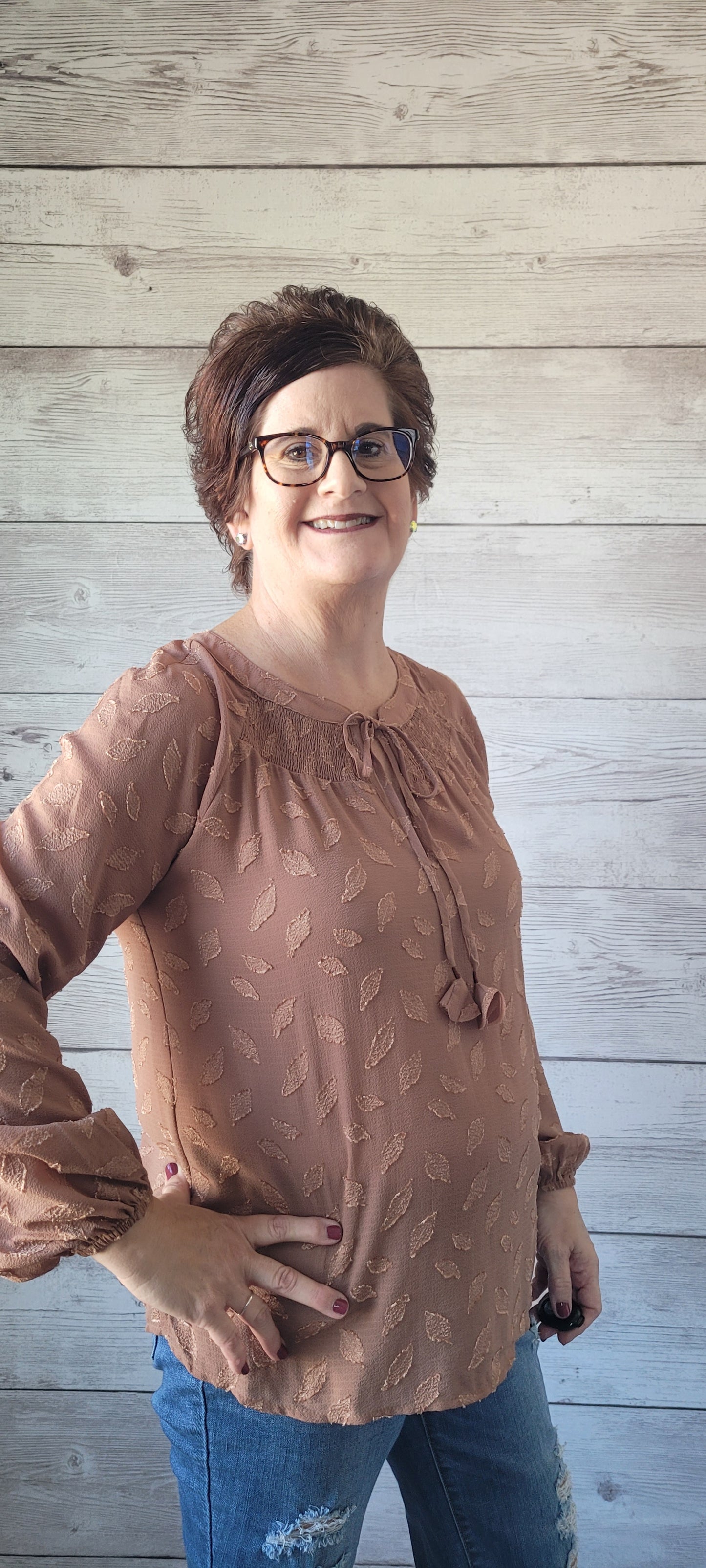 Be pretty as a picture in this blouse! This adorable blouse features a split round neck, a smocked yoke detail, and puff sleeves with elastic cuffs. Perfect for any occasion, this blouse will have you spun around in style! Sizes small through large.