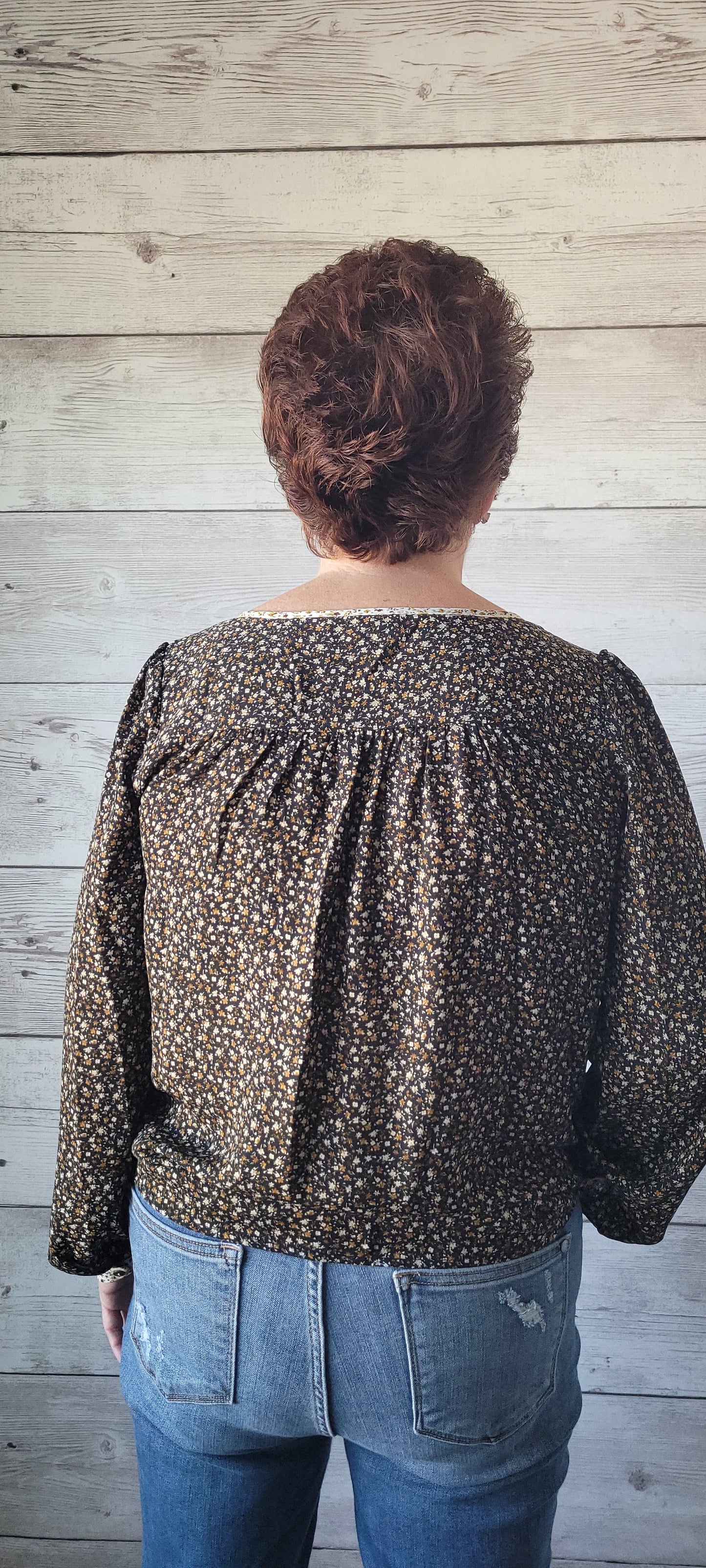 Elevate your outfit with the Luna Black & Ivory Floral Blouse! This blouse features a front tie and split round neck for an undeniably fun and flirty look, plus cute button cuff sleeves for an extra stylish touch. Jazz up any occasion with this unique and playful garment and bring the party wherever you go! Small through large.