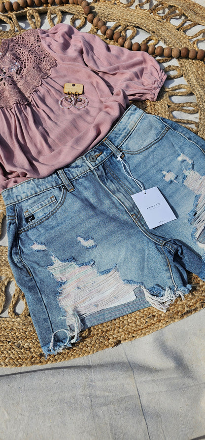 These denim distressed shorts are a light wash, high rise, frayed hem with hues of pink and blue. They are cute, edgy and scream summer vibes! Sizes small through x-large.