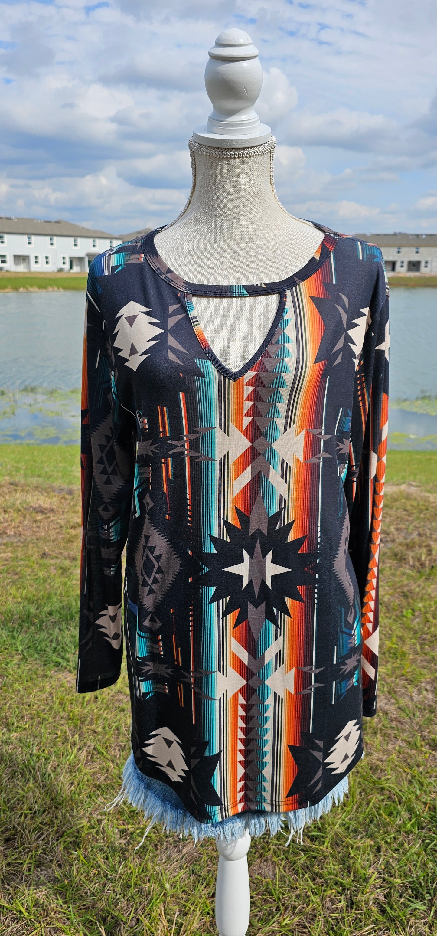 This is a comfy and casual long sleeve top. It features a rounded neckline with a V shaped cutout, long sleeves, Aztec design. Imagine yourself going to the rodeo, or line dancing. Whatever your adventure is, this is the shirt! Sizes small through x-large.
