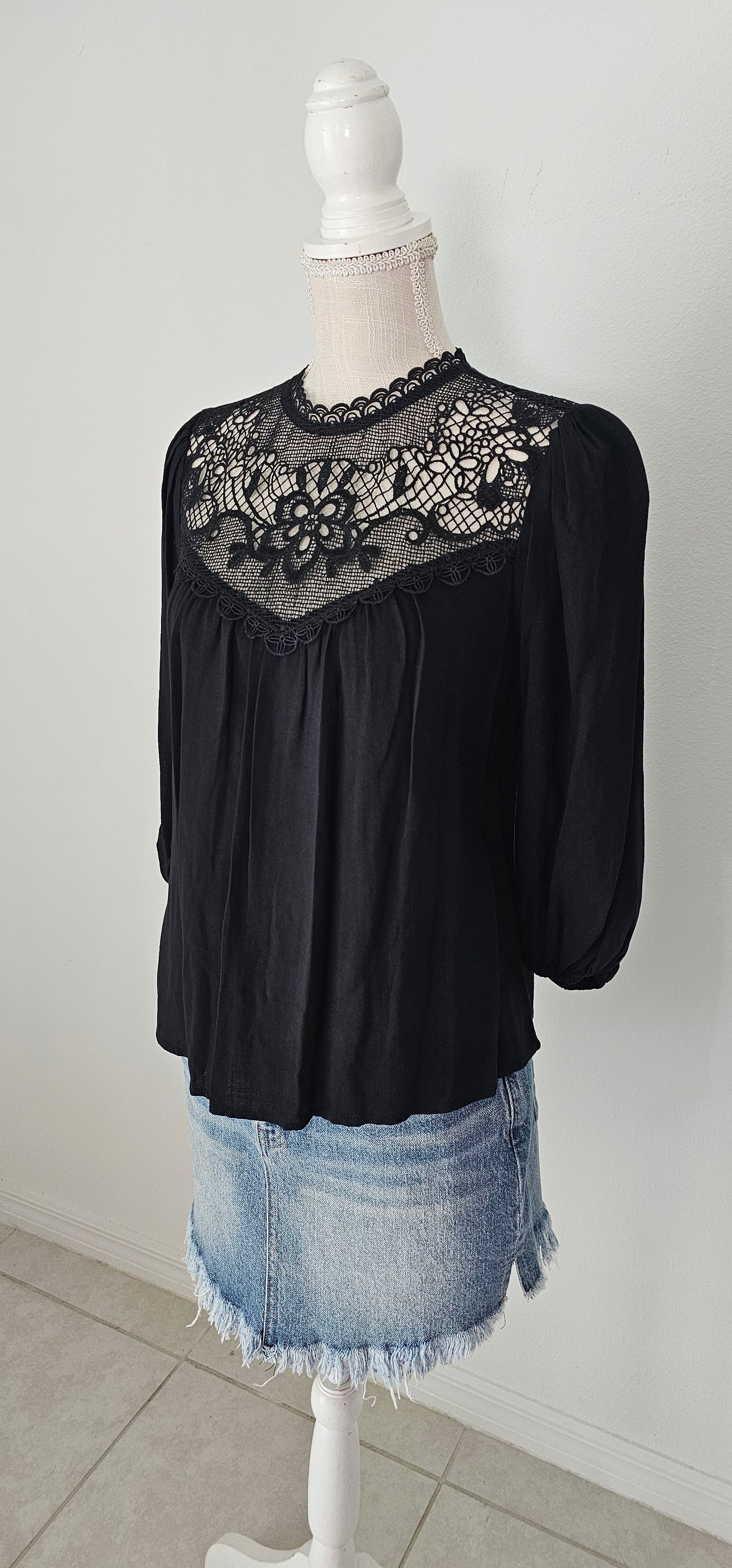Rock your look with this ravishing top that'll take your fashion to the next level! With its elegant lace mock neck, stylish back-button closure with keyhole, and oh-so-pretty front lace inset and pleated bubble sleeves, you'll be sure to draw admiring glances wherever you go. Let's get fabulous! Sizes small through large.