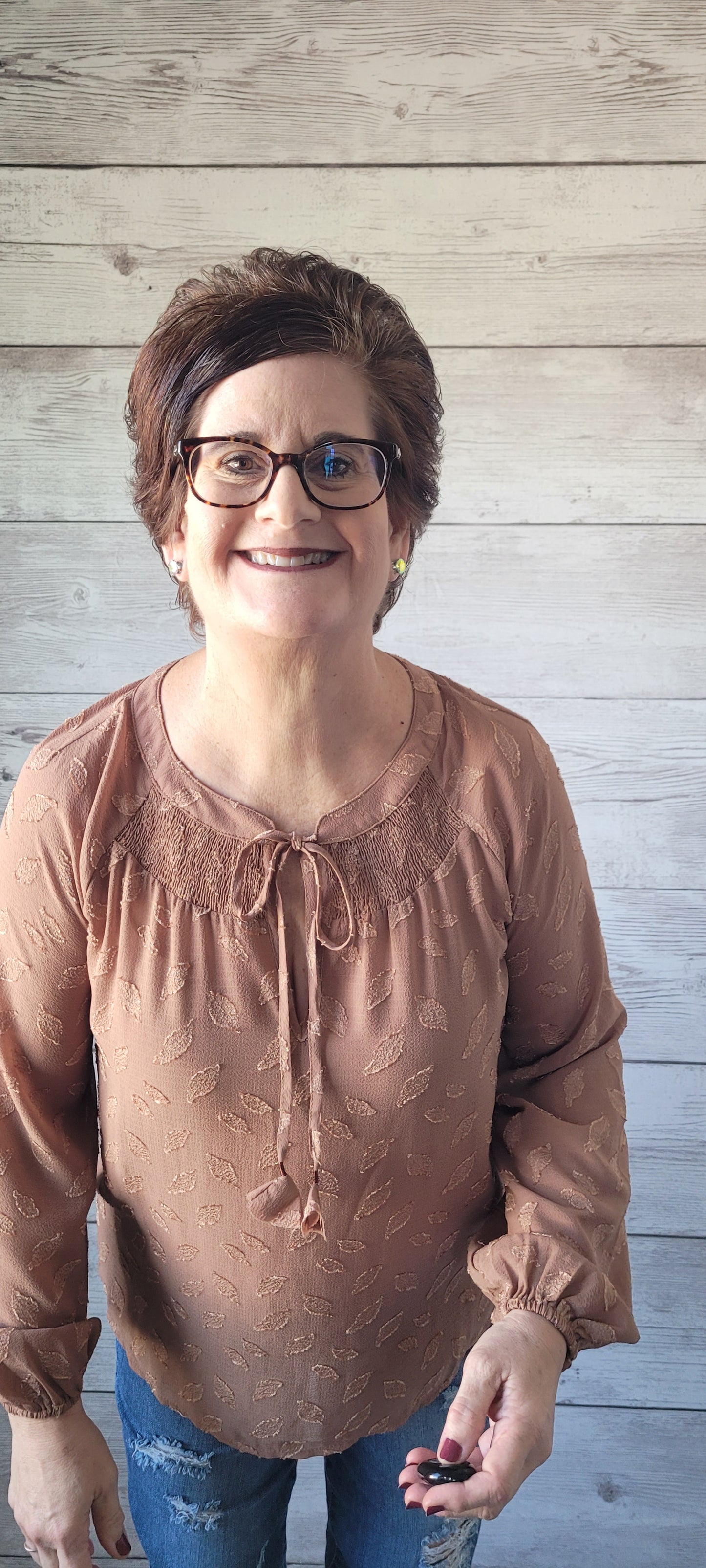 Be pretty as a picture in this blouse! This adorable blouse features a split round neck, a smocked yoke detail, and puff sleeves with elastic cuffs. Perfect for any occasion, this blouse will have you spun around in style! Sizes small through large.
