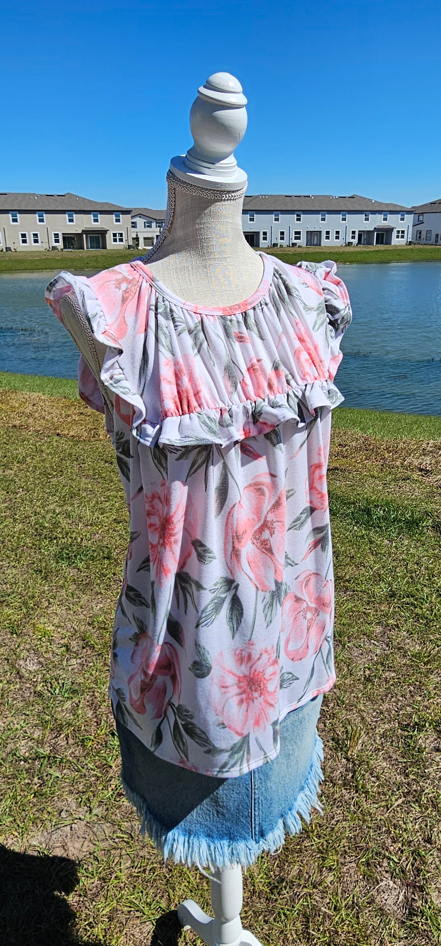 “Garden Goddess” is a comfy and casual top! This sleeveless white shirt features a beautiful pink and sage floral print. It is a baby doll top with rounded neckline, ruffled details on sleeves and chest. This top is so soft and comfy! There is a terry cloth texture inside. Sizes small through large.