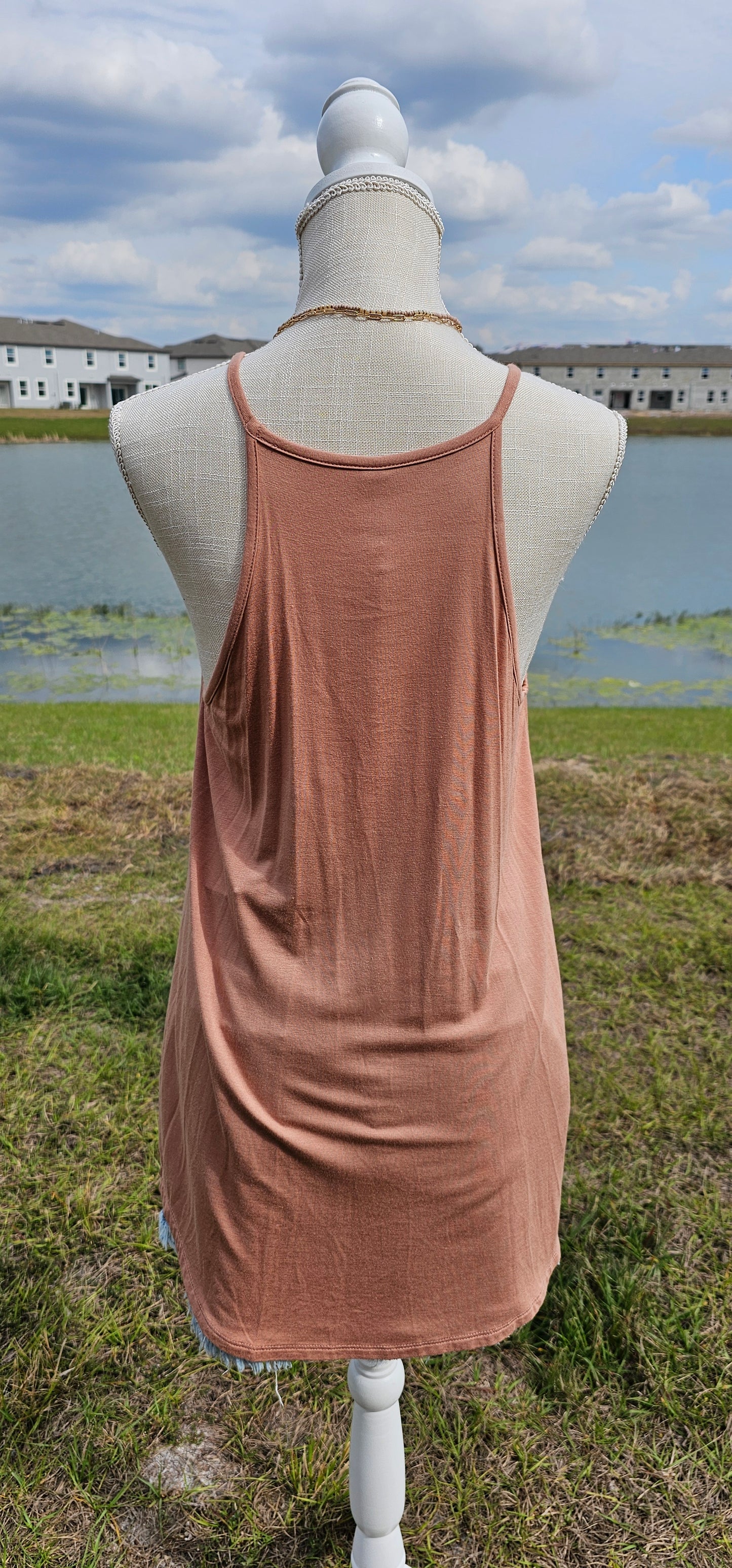 This tank is a must have! It is simple and basic. It is easy for layering or great all by itself! The tank is a relaxed fit, featuring a crocheted floral rounded neckline, curved hemline, and fixed non-adjustable straps. Color is ash mocha. Pair with your favorite denim jeans, tucking the corner of the tank into your belt loop or dress it up with an edgy skirt. Don’t be afraid to get creative! Sizes small through x-large