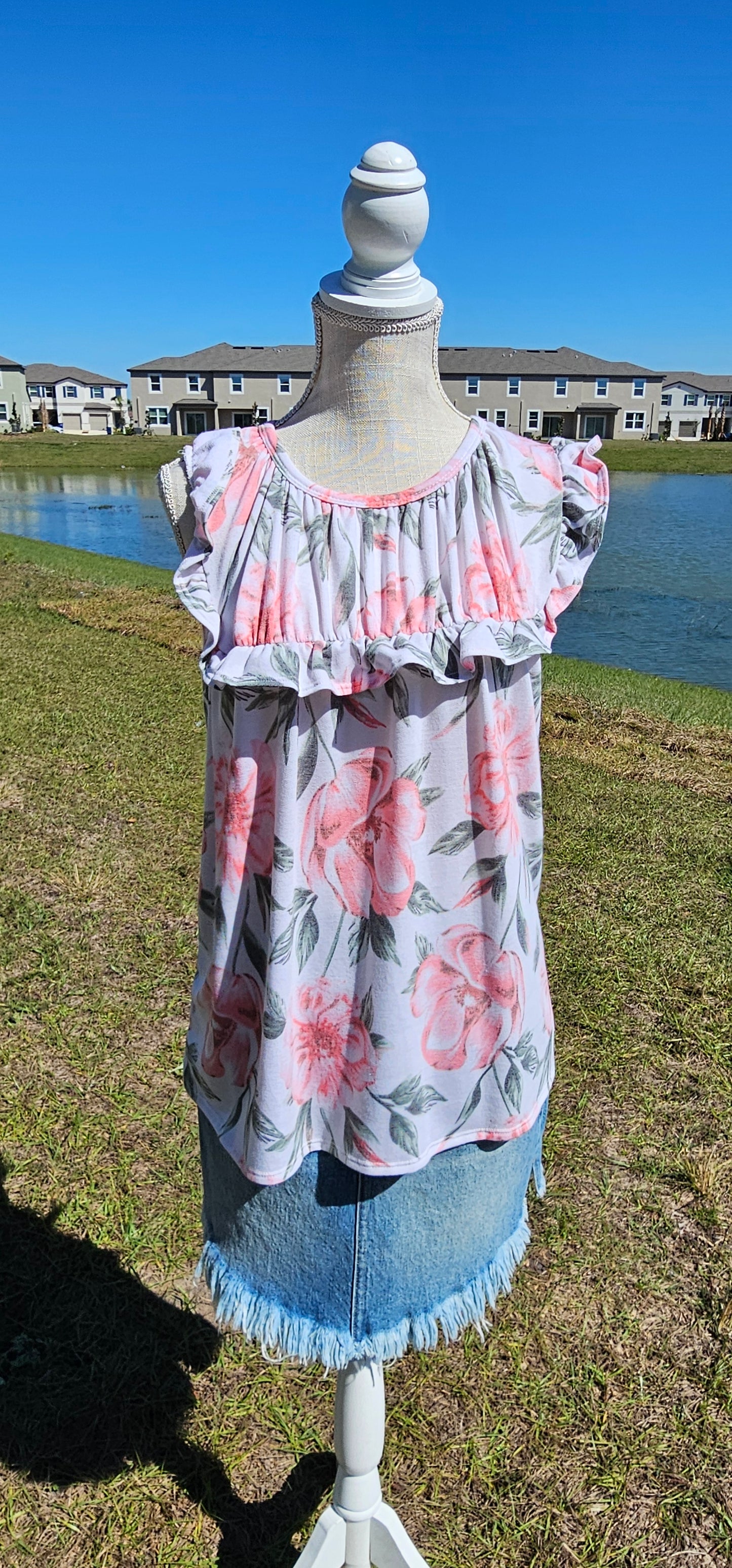 “Garden Goddess” is a comfy and casual top! This sleeveless white shirt features a beautiful pink and sage floral print. It is a baby doll top with rounded neckline, ruffled details on sleeves and chest. This top is so soft and comfy! There is a terry cloth texture inside. Sizes small through large.