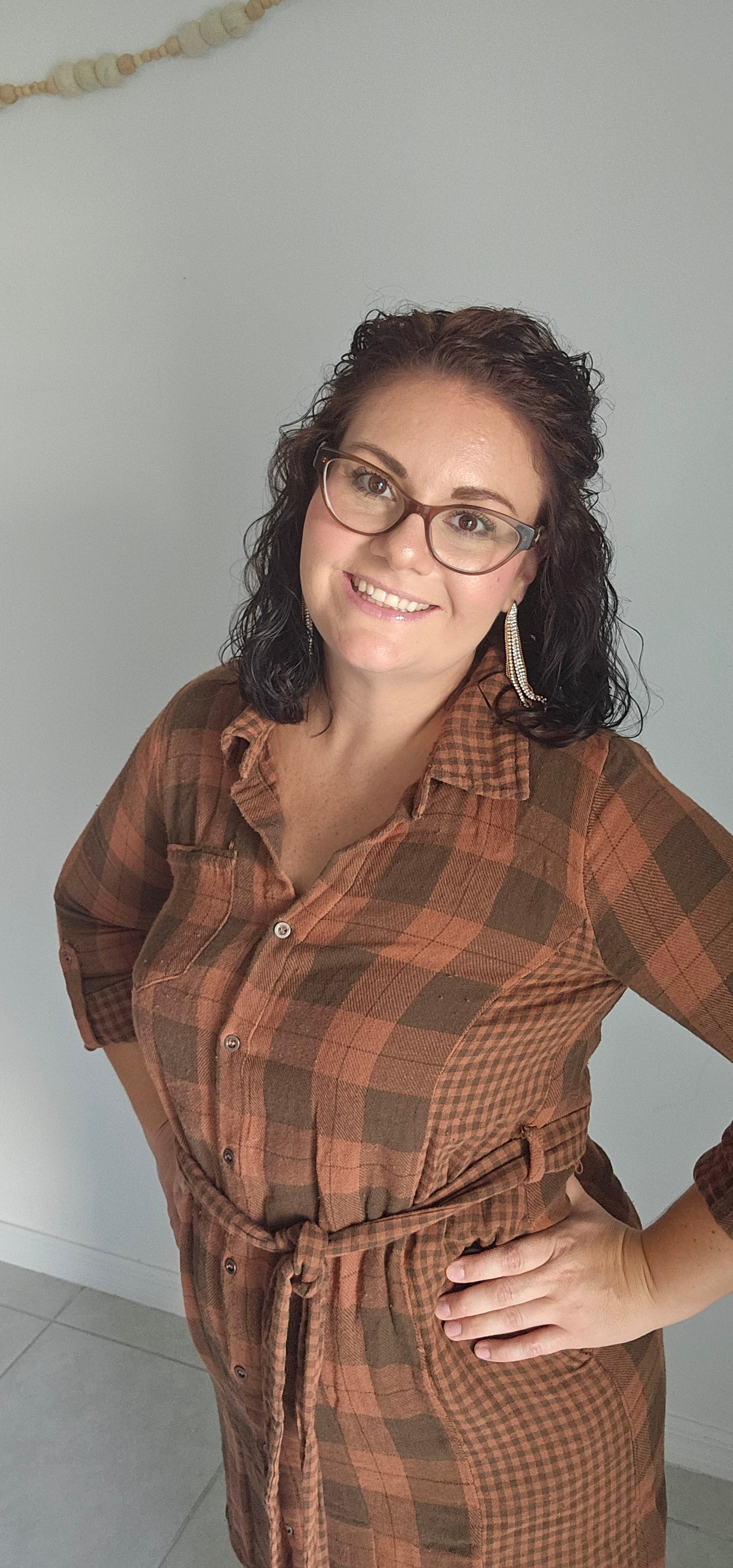 Step into autumn in style with the Riley Rust Plaid Shirt Dress! This warm plaid dress has all the details that make it a stand-out: buttoned front, tie-waist belt, plus functional chest and side pockets. Roll up the sleeves and get ready to kick up some fallen leaves. It's sure to get you noticed! Sizes small through large.