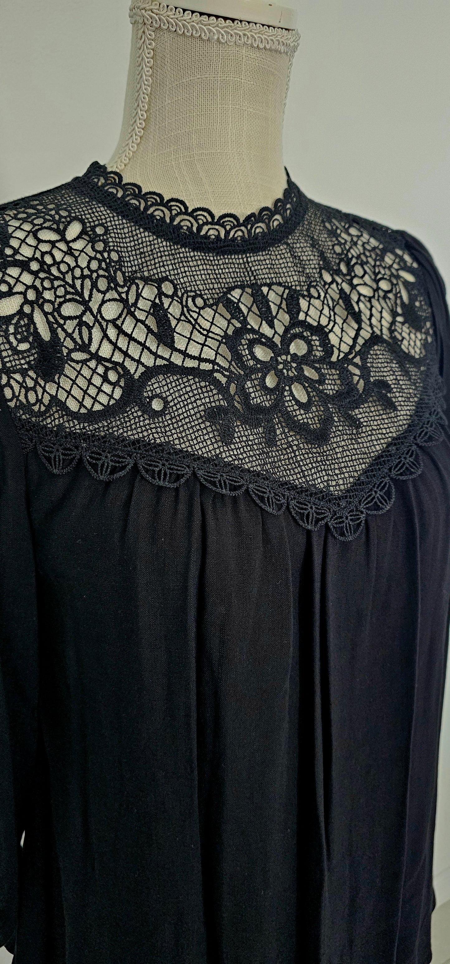 Rock your look with this ravishing top that'll take your fashion to the next level! With its elegant lace mock neck, stylish back-button closure with keyhole, and oh-so-pretty front lace inset and pleated bubble sleeves, you'll be sure to draw admiring glances wherever you go. Let's get fabulous! Sizes small through large.