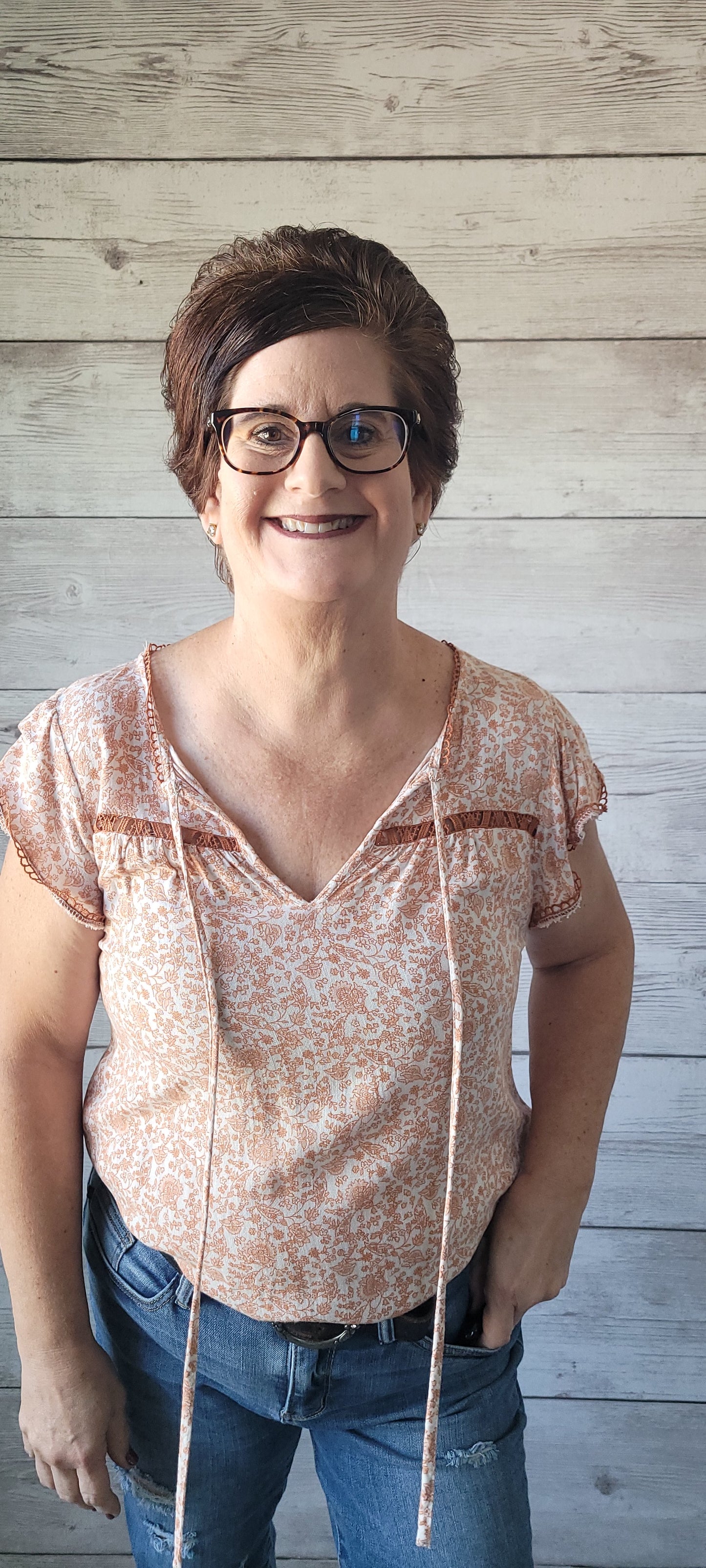 Dress to impress with this soft and dreamy "Tina Dusty Peach" top! With a split round neckline, a front tie with keyhole, flirty short sleeves, and a front chest-line lace, you'll look like you stepped out of a fairy tale. Puttin' the "wow" into every outfit! Sizes small through large.