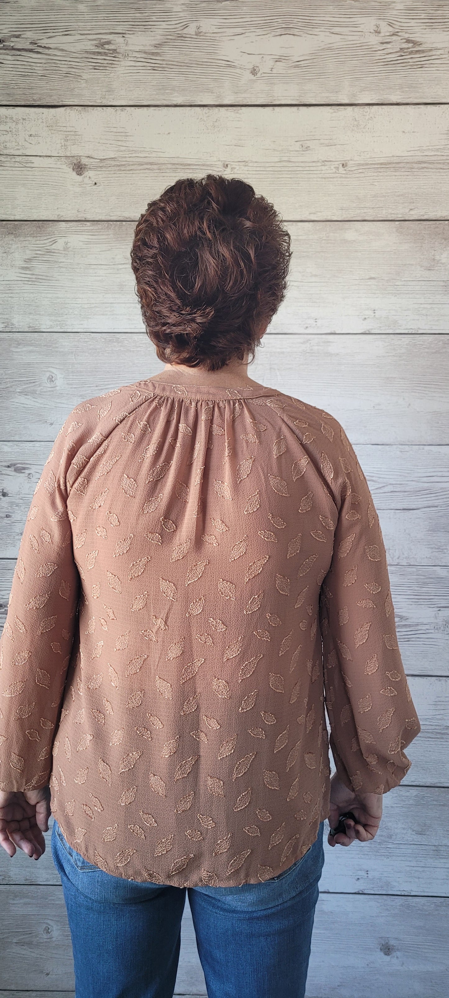 Be pretty as a picture in this blouse! This adorable blouse features a split round neck, a smocked yoke detail, and puff sleeves with elastic cuffs. Perfect for any occasion, this blouse will have you spun around in style! Sizes small through large.