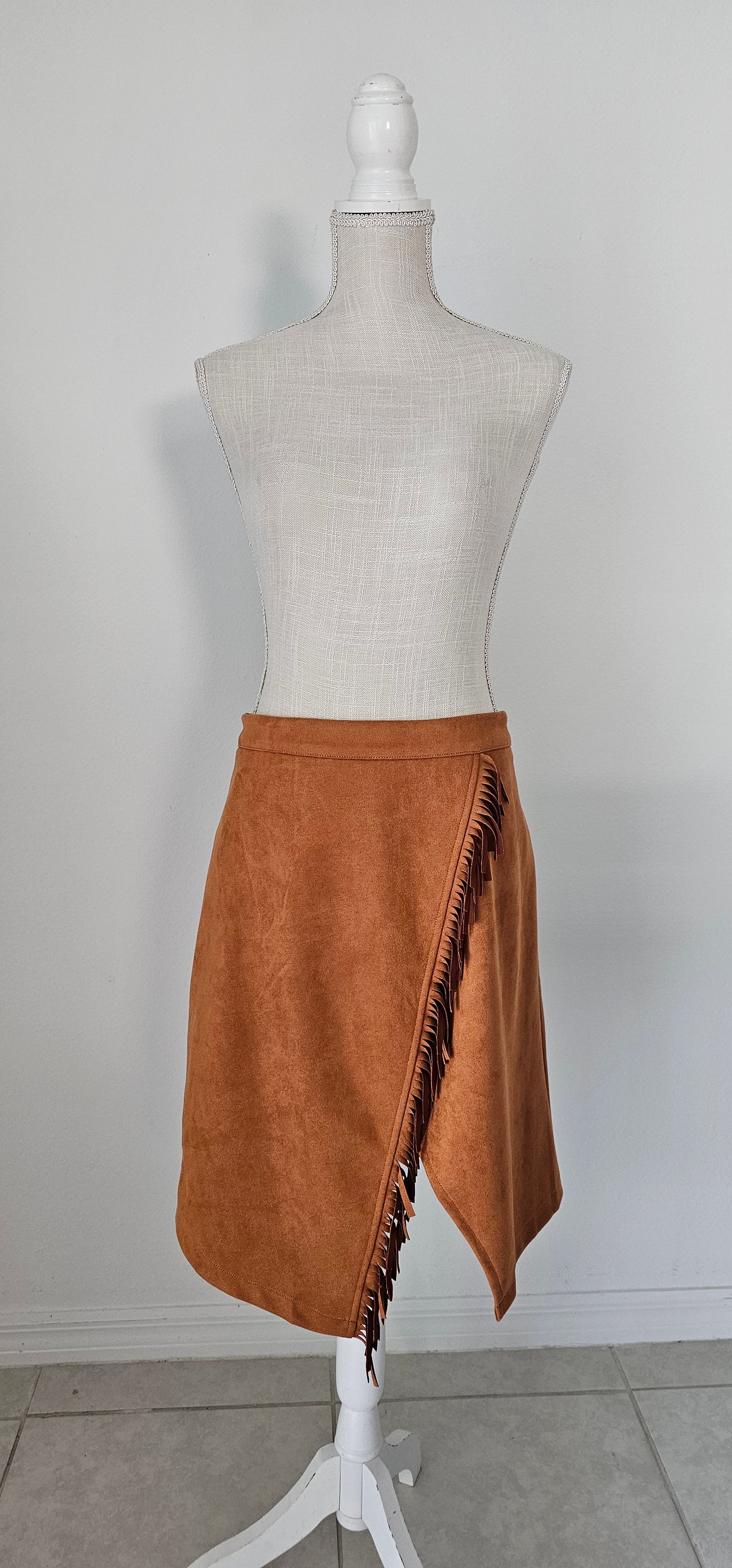 This wrap skirt features fringe accents. Pair it with your favorite top and heels for an effortless look. Size x-large.