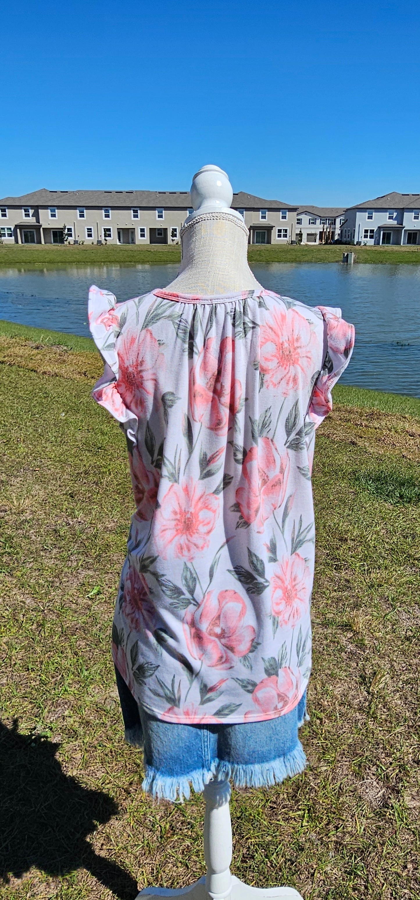 “Garden Goddess” is a comfy and casual top! This sleeveless white shirt features a beautiful pink and sage floral print. It is a baby doll top with rounded neckline, ruffled details on sleeves and chest. This top is so soft and comfy! There is a terry cloth texture inside. Sizes small through large.