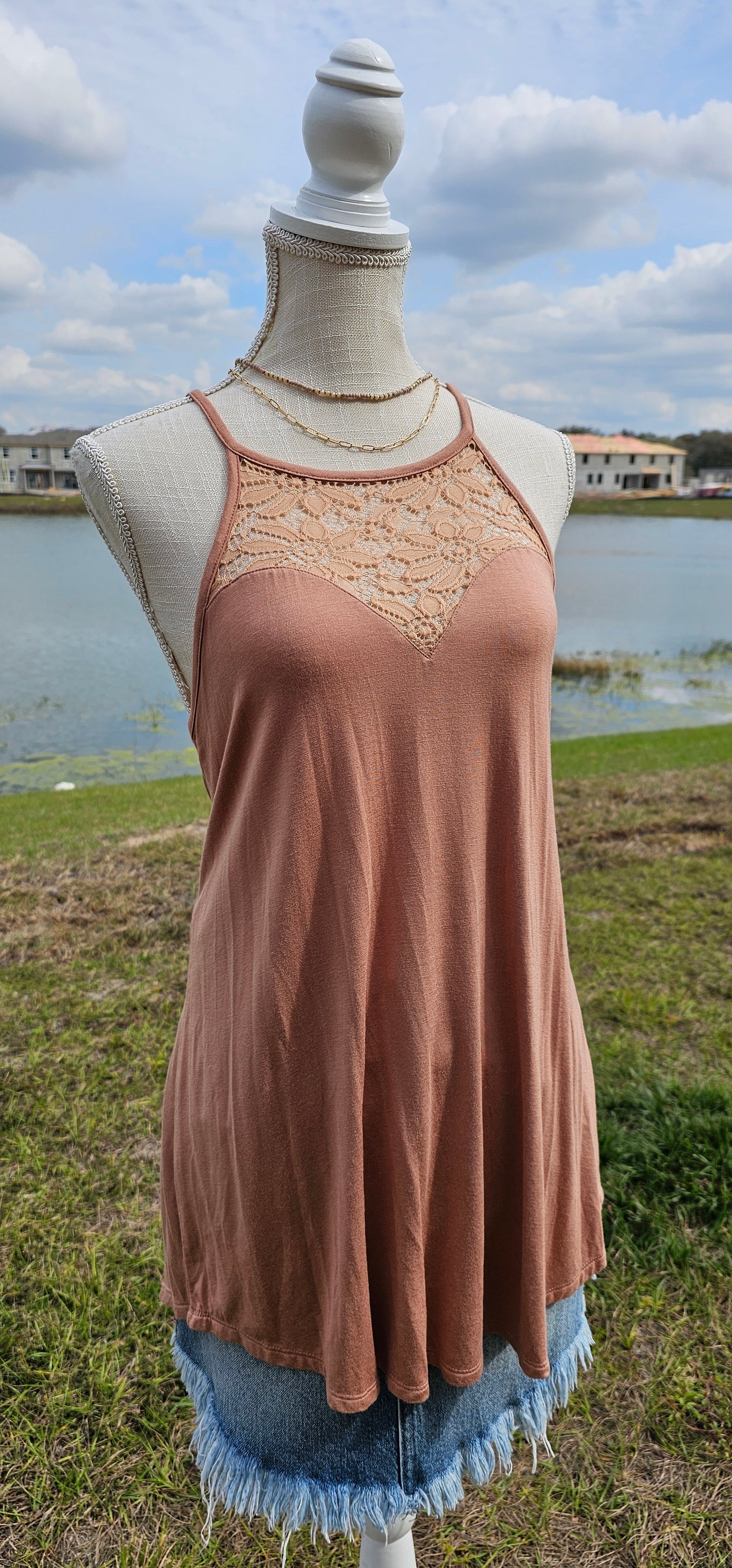 This tank is a must have! It is simple and basic. It is easy for layering or great all by itself! The tank is a relaxed fit, featuring a crocheted floral rounded neckline, curved hemline, and fixed non-adjustable straps. Color is ash mocha. Pair with your favorite denim jeans, tucking the corner of the tank into your belt loop or dress it up with an edgy skirt. Don’t be afraid to get creative! Sizes small through x-large