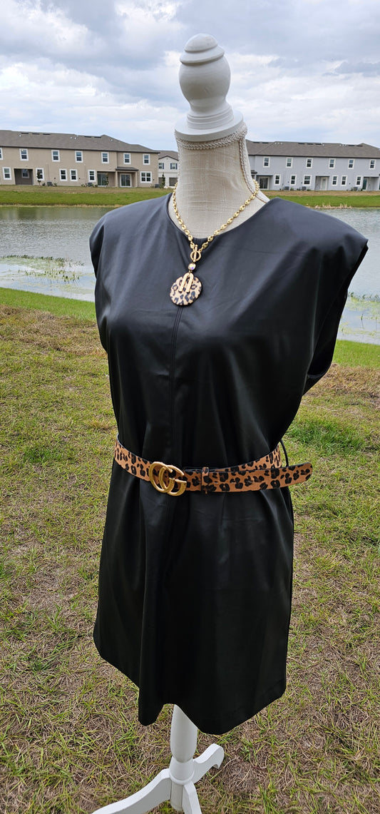This vegan leather sleeveless dress offers shoulder pads, belt loops (belt not included), back opening with button closure, and is matte vegan leather. Go ahead and strut your stuff! It is great for a date, going to the office, or hanging out with the girls. Change the look of your dress by wearing different style belts. Sizes small through x-large.