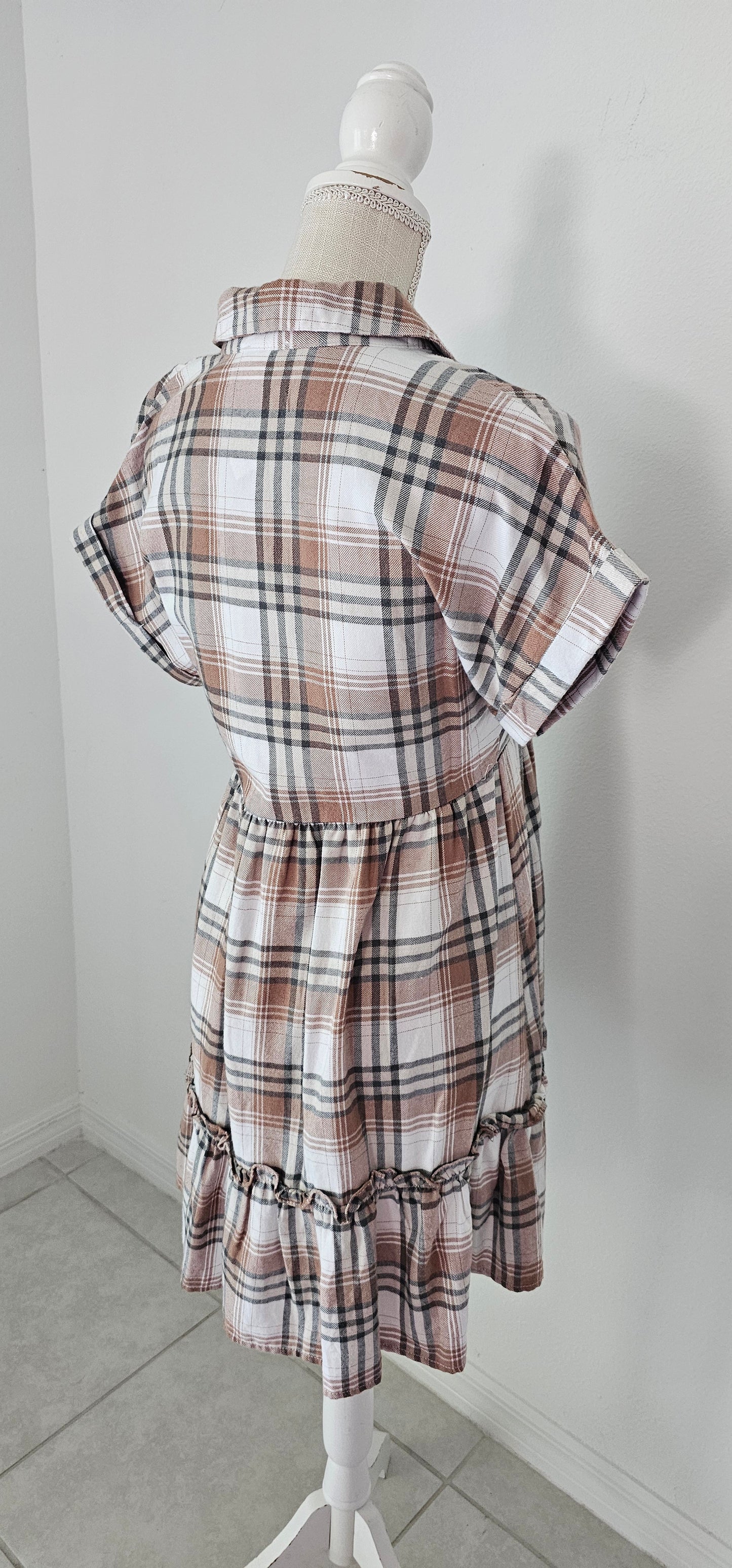 Rock your modern-meets-rustic side in this plaid mini dress! Featuring a collared neckline with button down closure, cinched waist, and a ruffle hem, you'll look fly af (as fashionable) no matter the occasion. With pocket detail, this pleated plaid piece will have you looking cute and stylish all day - yesssss girl! Sizes small through large.