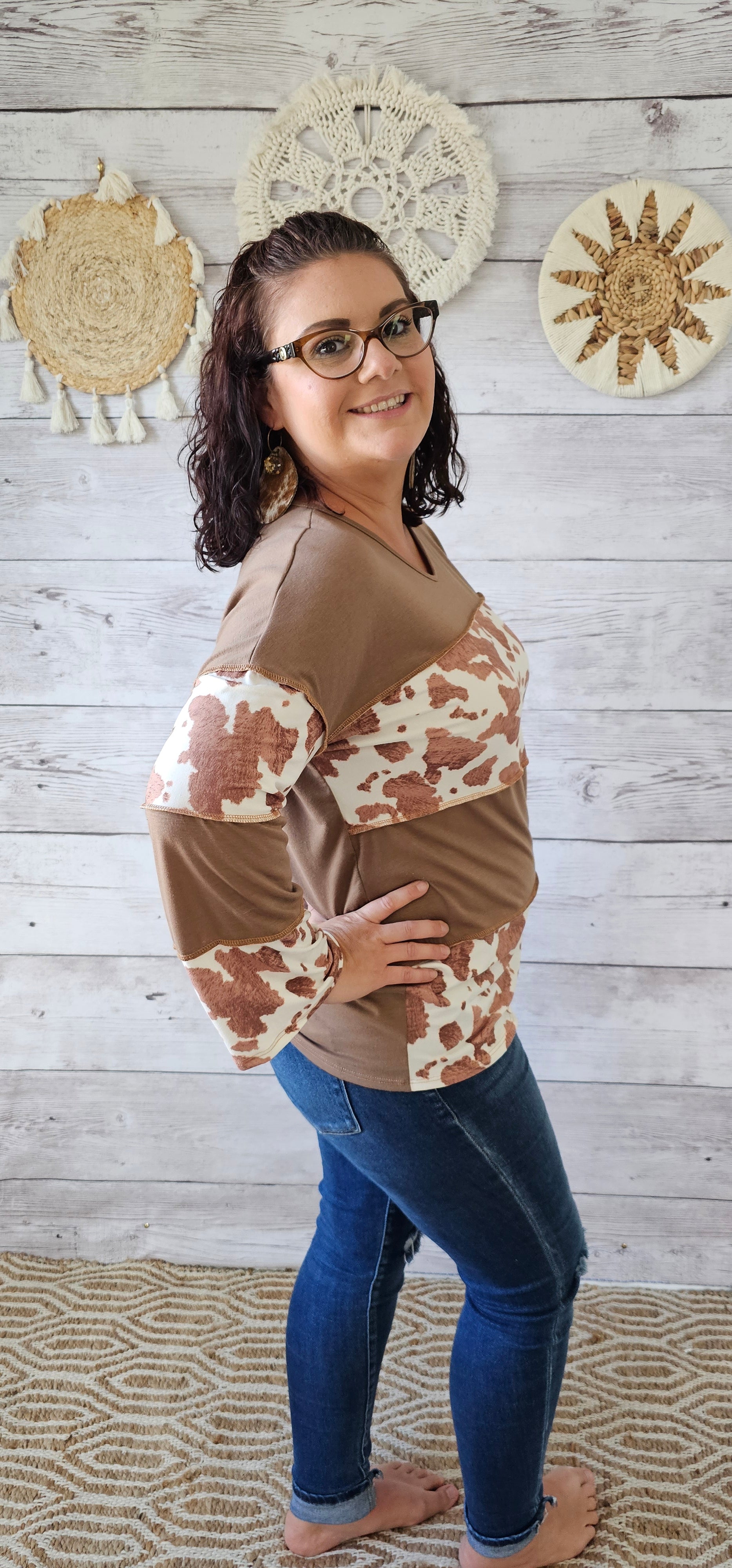 This is a long sleeve, v-neck top with an exposed seam. Cow print and mocha layers. Sizes small through x-large.