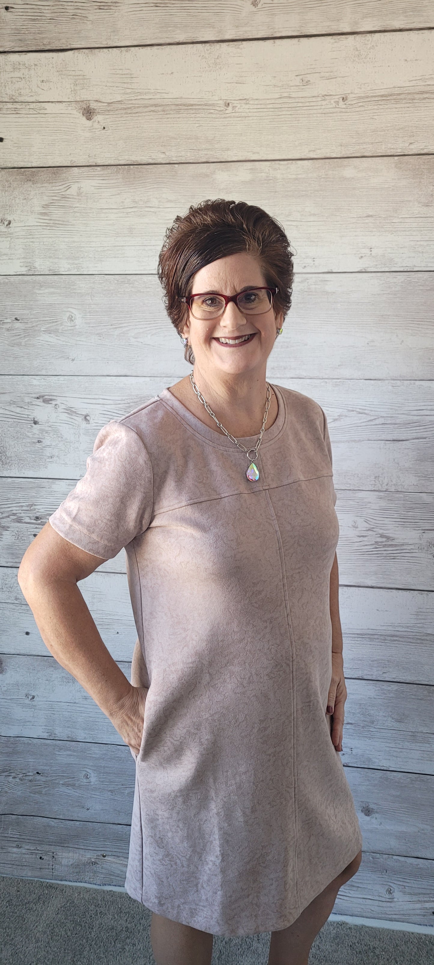 Dress to impress in this "Winona Mauve Printed Suede Shift Dress" and show off your country flair! With its round neckline, short sleeves, side pockets, and zipper back closure, it’s sure to be your go-to look for any special occasion. Yee-haw! Sizes small through large.