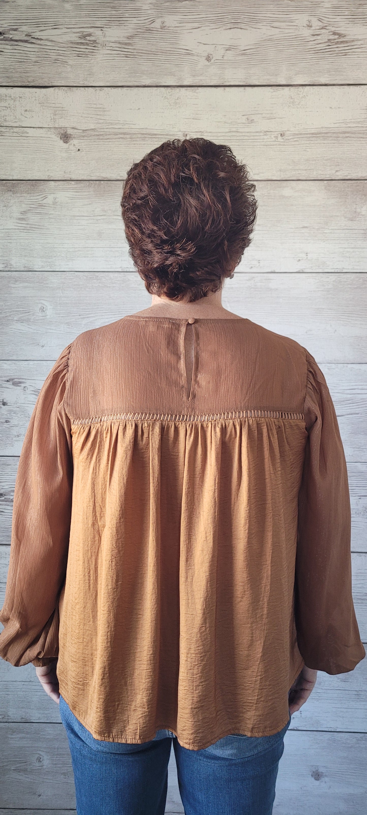Feel like royalty in our Sophia Camel Satin Blouse! With a round neck and keyhole back button closure, this top offers the perfect balance between style and comfort. Puff sleeves with gathered ruffles and ladder trim detail add a unique touch, as does the front and back shirring. Shine bright with your own golden thread of Lurex contrast! Sizes small through large.