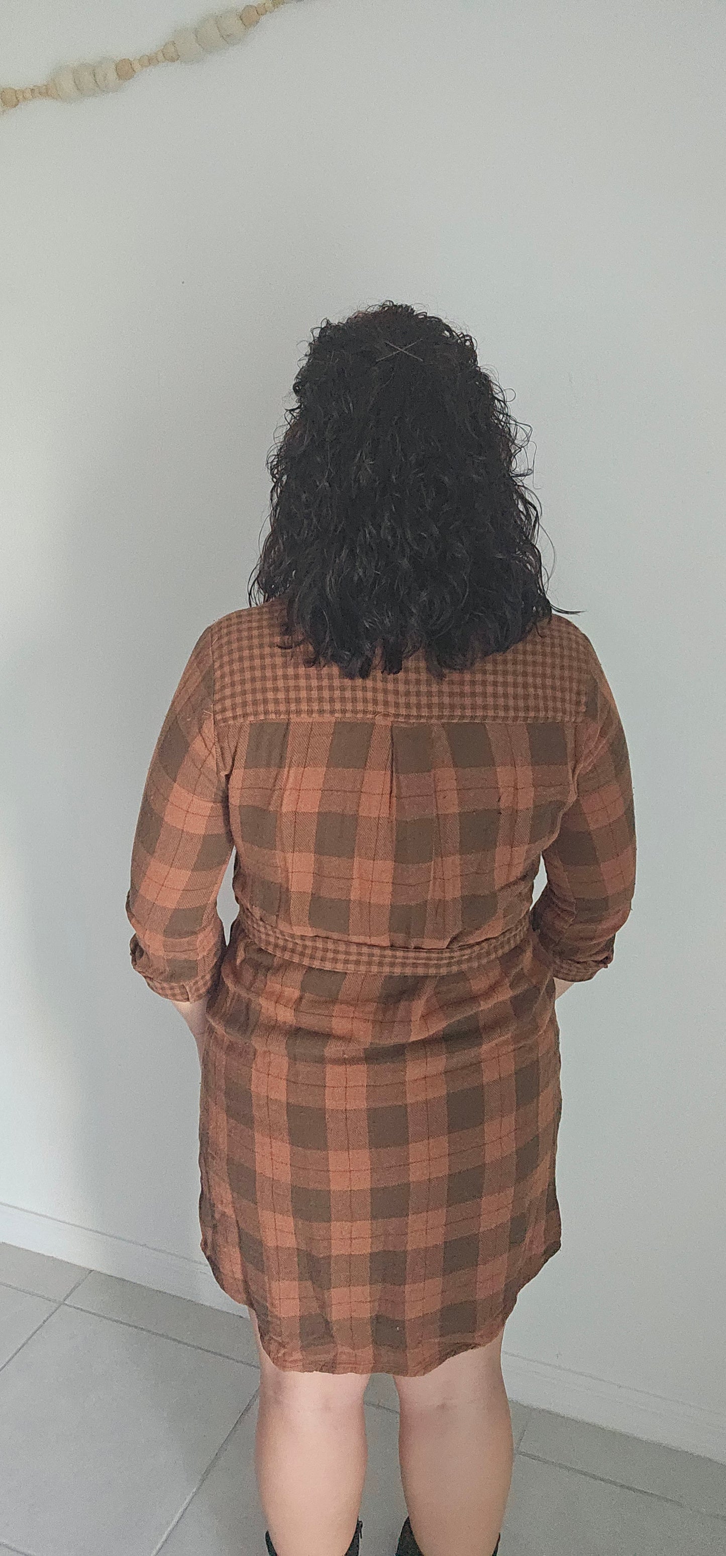 Step into autumn in style with the Riley Rust Plaid Shirt Dress! This warm plaid dress has all the details that make it a stand-out: buttoned front, tie-waist belt, plus functional chest and side pockets. Roll up the sleeves and get ready to kick up some fallen leaves. It's sure to get you noticed! Sizes small through large.