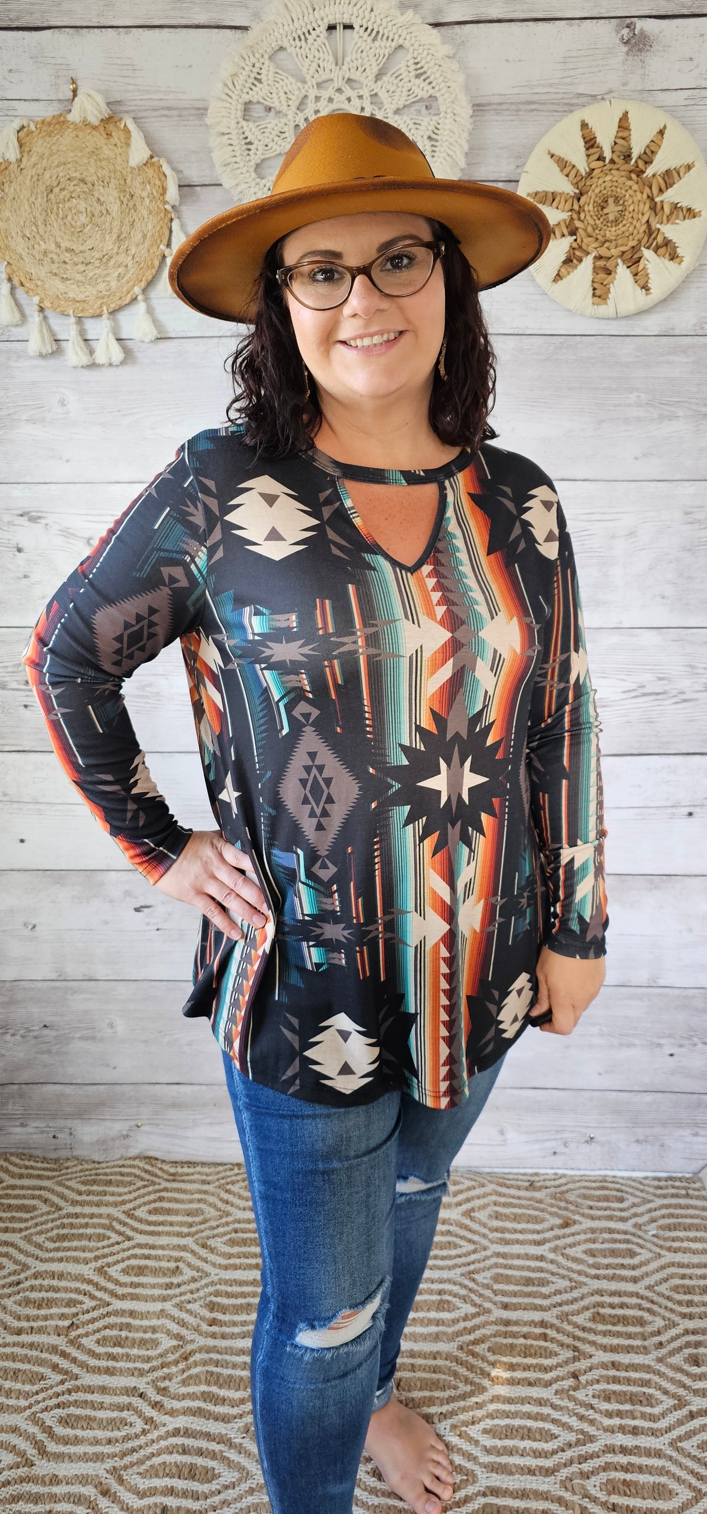 This is a comfy and casual long sleeve top. It features a rounded neckline with a V shaped cutout, long sleeves, Aztec design. Imagine yourself going to the rodeo, or line dancing. Whatever your adventure is, this is the shirt! Sizes small through x-large.