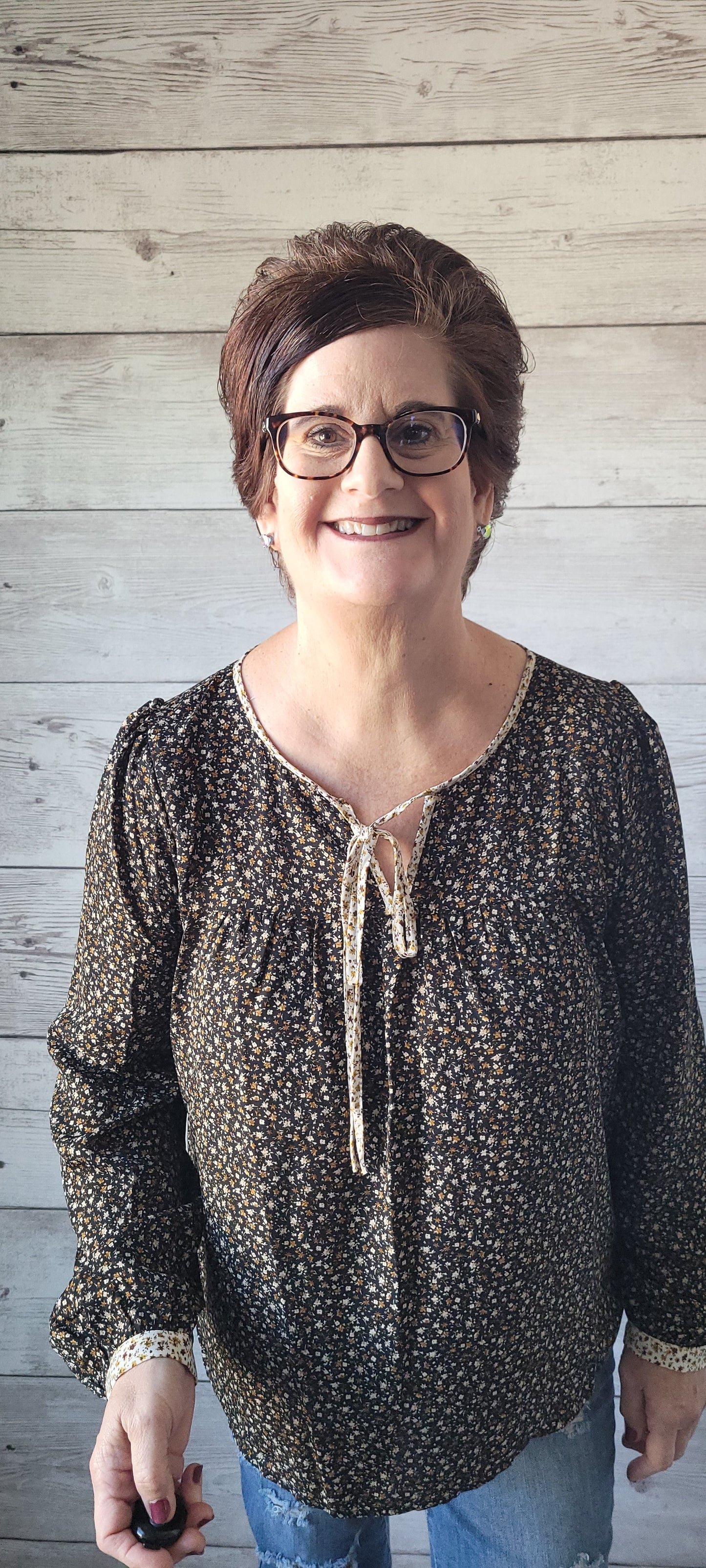 Elevate your outfit with the Luna Black & Ivory Floral Blouse! This blouse features a front tie and split round neck for an undeniably fun and flirty look, plus cute button cuff sleeves for an extra stylish touch. Jazz up any occasion with this unique and playful garment and bring the party wherever you go! Small through large.