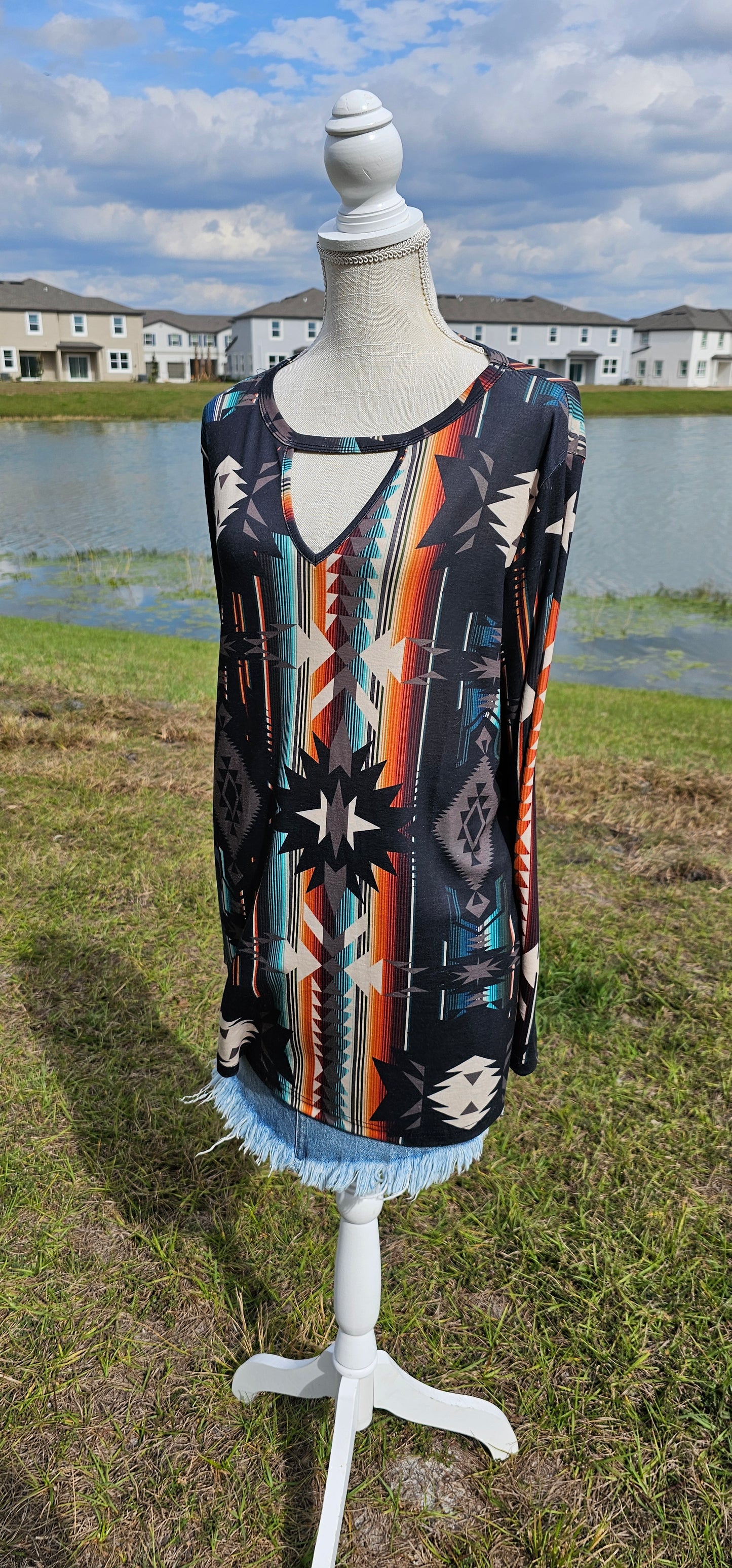 This is a comfy and casual long sleeve top. It features a rounded neckline with a V shaped cutout, long sleeves, Aztec design. Imagine yourself going to the rodeo, or line dancing. Whatever your adventure is, this is the shirt! Sizes small through x-large.