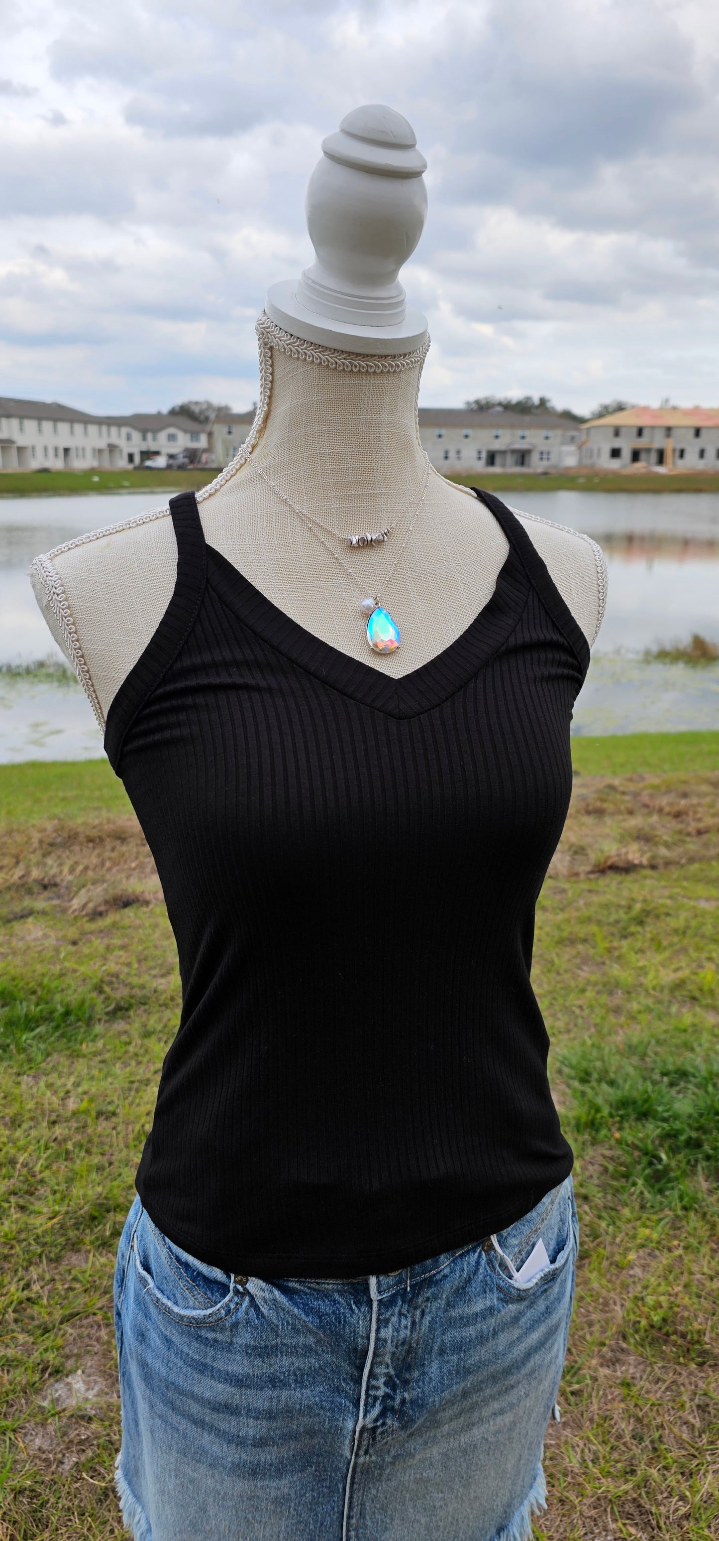 This “Basic Babe Tank Top: Black” features a ribbed fabric, sleeveless tank top with v-neck and back. This is a great basic staple piece! Sizes small through x-large.