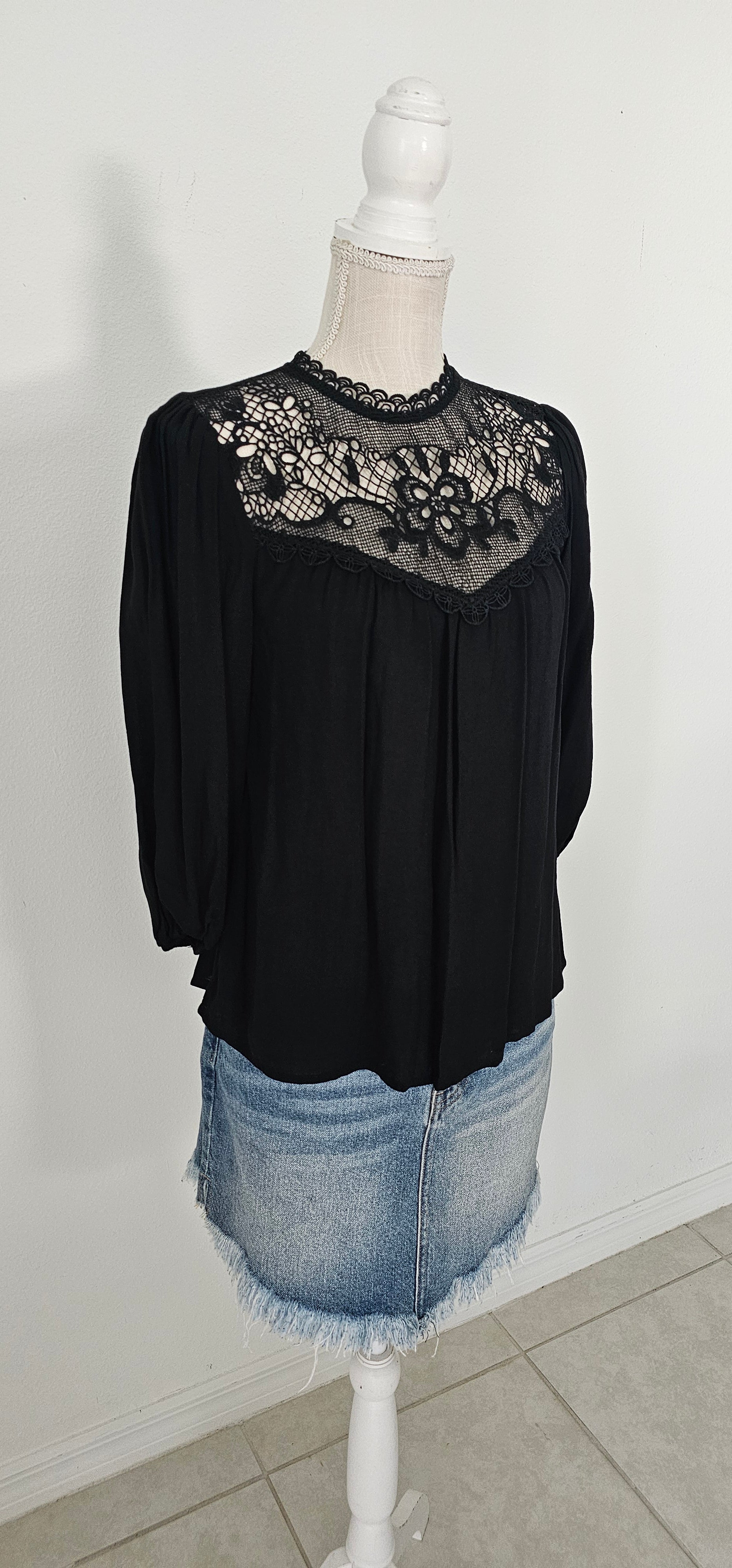 Rock your look with this ravishing top that'll take your fashion to the next level! With its elegant lace mock neck, stylish back-button closure with keyhole, and oh-so-pretty front lace inset and pleated bubble sleeves, you'll be sure to draw admiring glances wherever you go. Let's get fabulous! Sizes small through large.