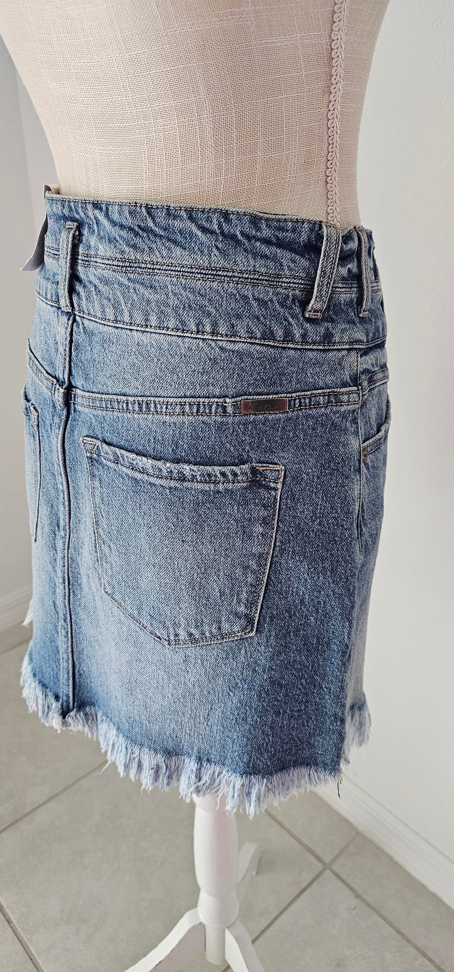 Imagine yourself in this cute denim high rise skirt. This skirt features a frayed hem. A jean skirt is a staple to anyone's life. This cute skirt you can dress up or down. Imagine yourself wearing this to the office, school, out on the town, or just because. This cute skirt can be worn with pretty much any top, sweater, or sweatshirt. Sizes small through x-large.