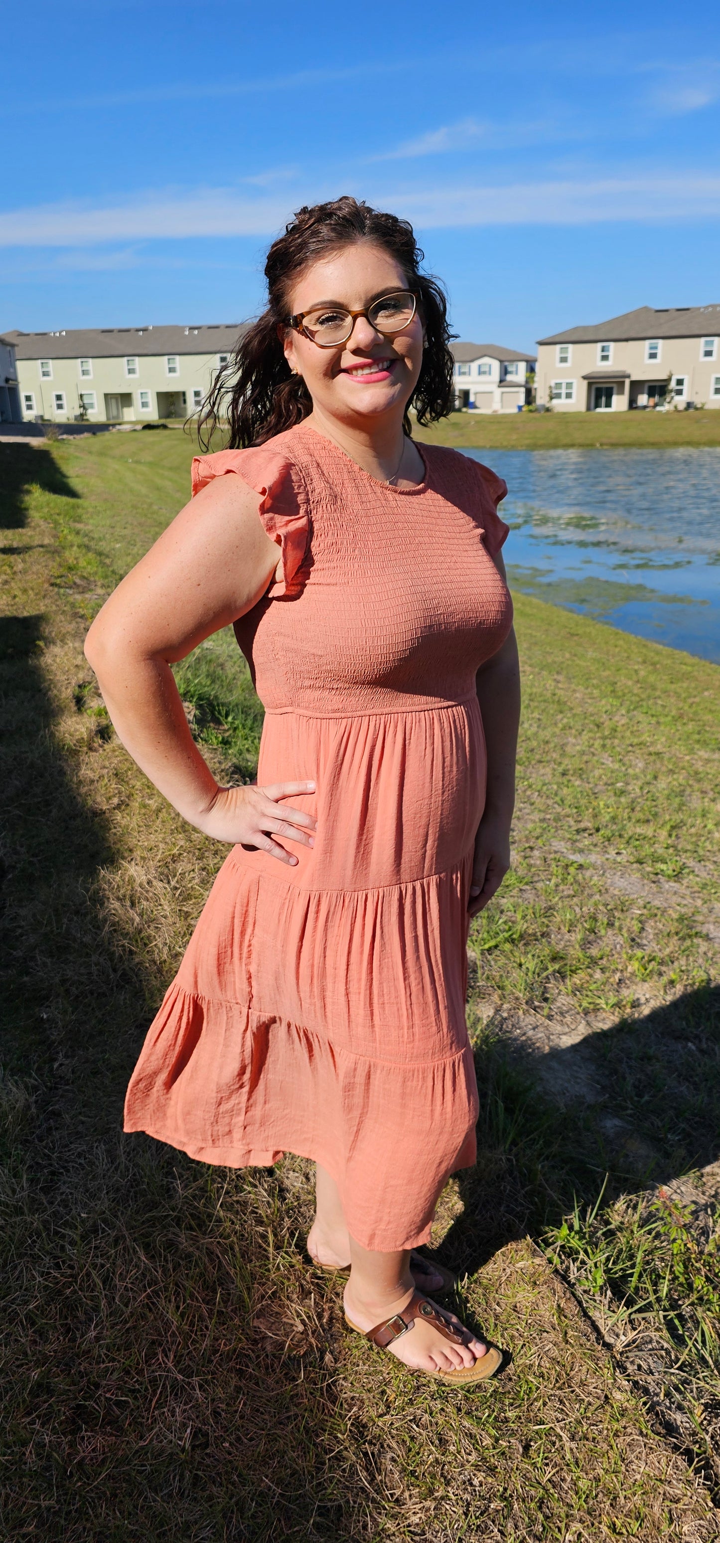This dress is ready to charm your day away! Flattering round neckline, keyhole-secured back neck button, and fluttery short cap sleeves combine with smocked body and tiered skirt for an oh-so-sweet silhouette. You'll be saying 'till tomorrow' in this cozy, lined midi dress! Sizes small through large.