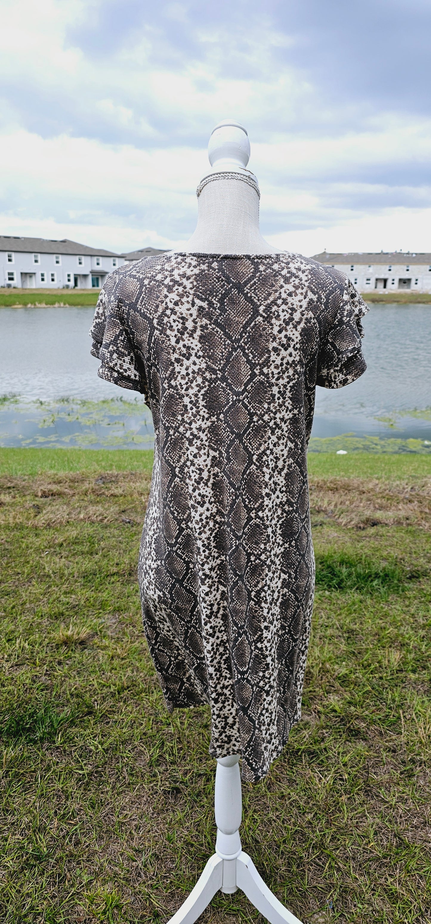 “Live In The Moment” is a snake print, waffle knit dress featuring ruffled layer sleeves, rounded neckline, and it sits above the knees. It is a soft, breathable material. This is unlined, non-sheer, and lightweight. This dress is cream and various browns. Sizes small through large.