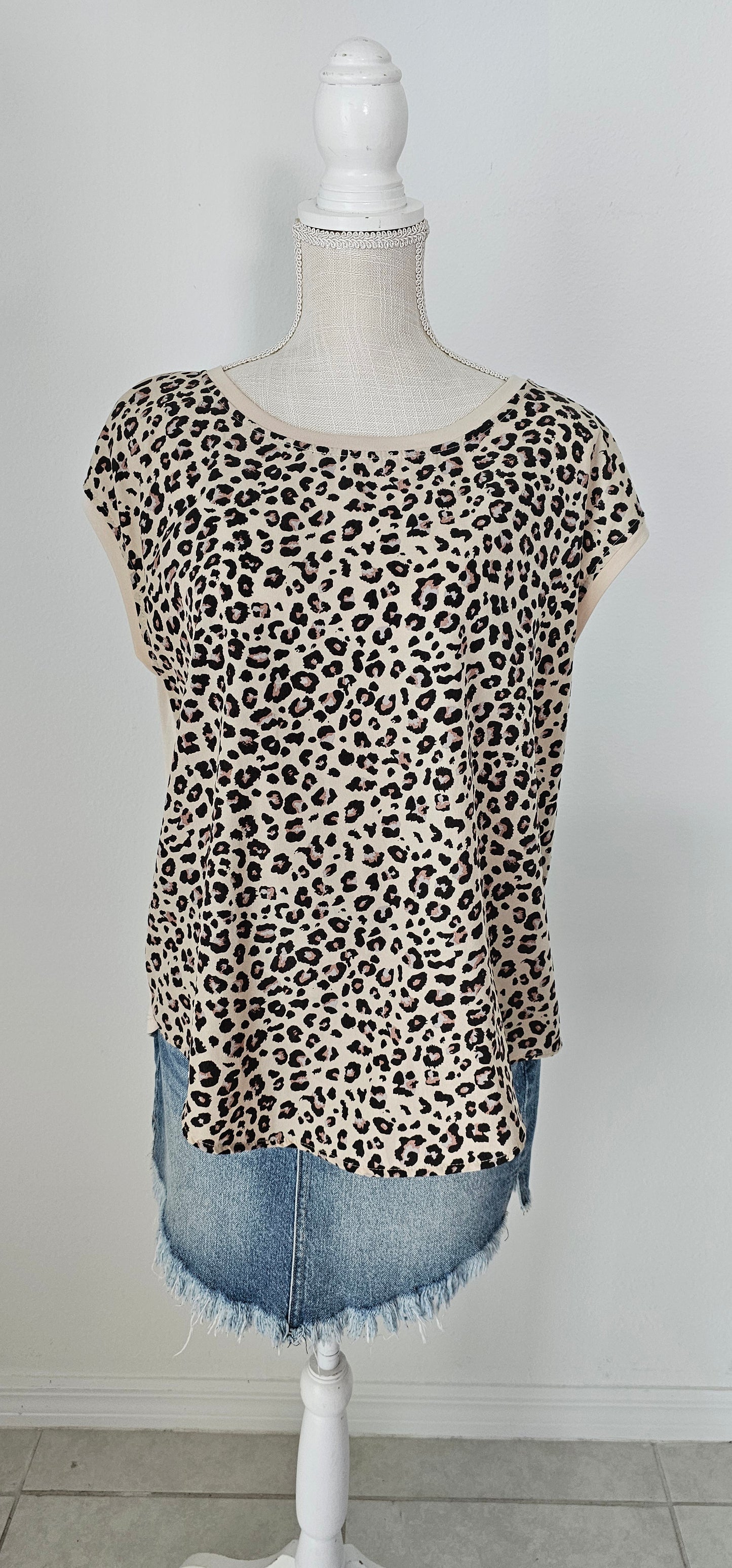 “Road Less Traveled” is a sleeveless top, with leopard print front (beige, brown, camel, agreeable gray) and contrast back, boat neckline, trimmed with beige soft modal, and rounded hemline. This is a satiny, silky soft high-low top. This is definitely a business or casual top. Sizes small through large.