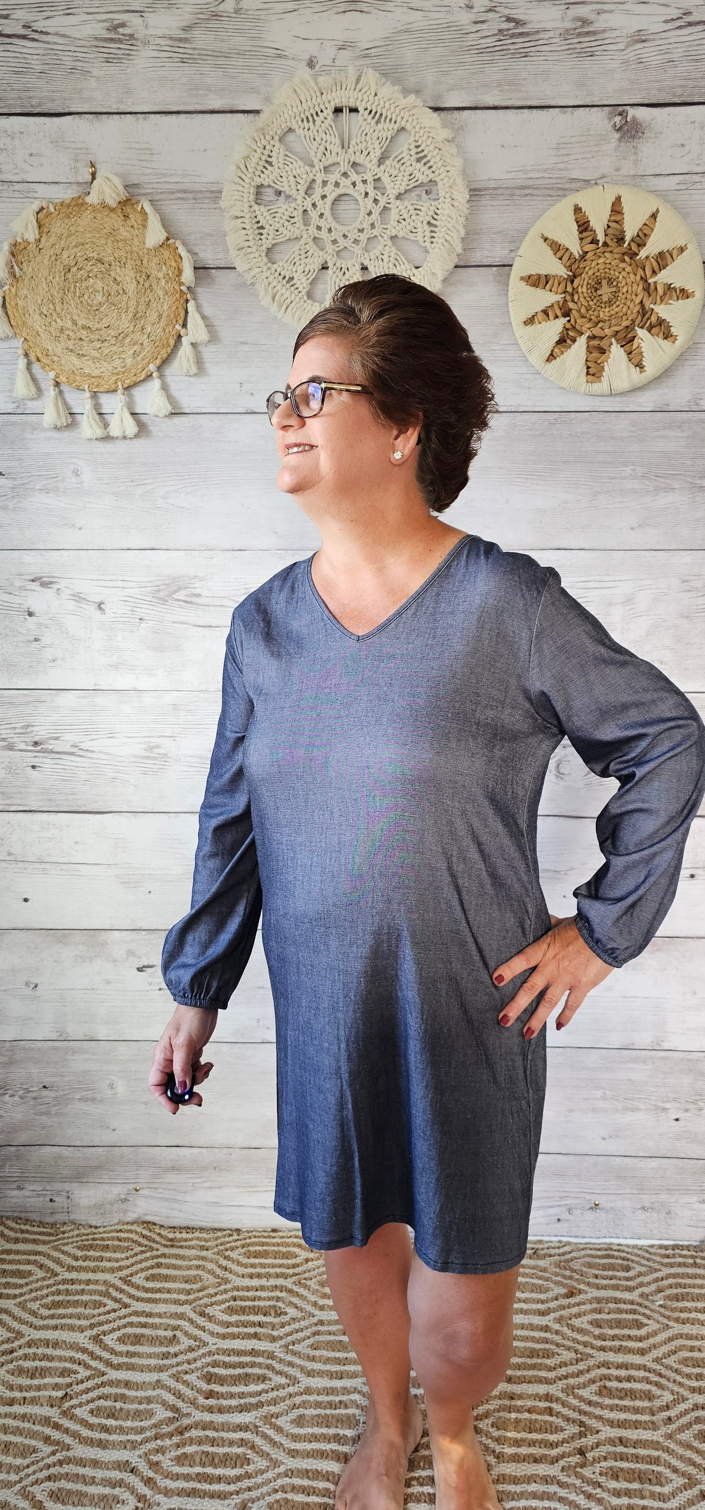 Imagine yourself in this dress going to the rodeo, line dancing, a party, or just hanging out with family and friends. This denim look dress offers a V-neck,  and long sleeves that are cinched at the wrist. This dress is very comfy as it has a lot of give and is roomy. Sizes small through x-large.