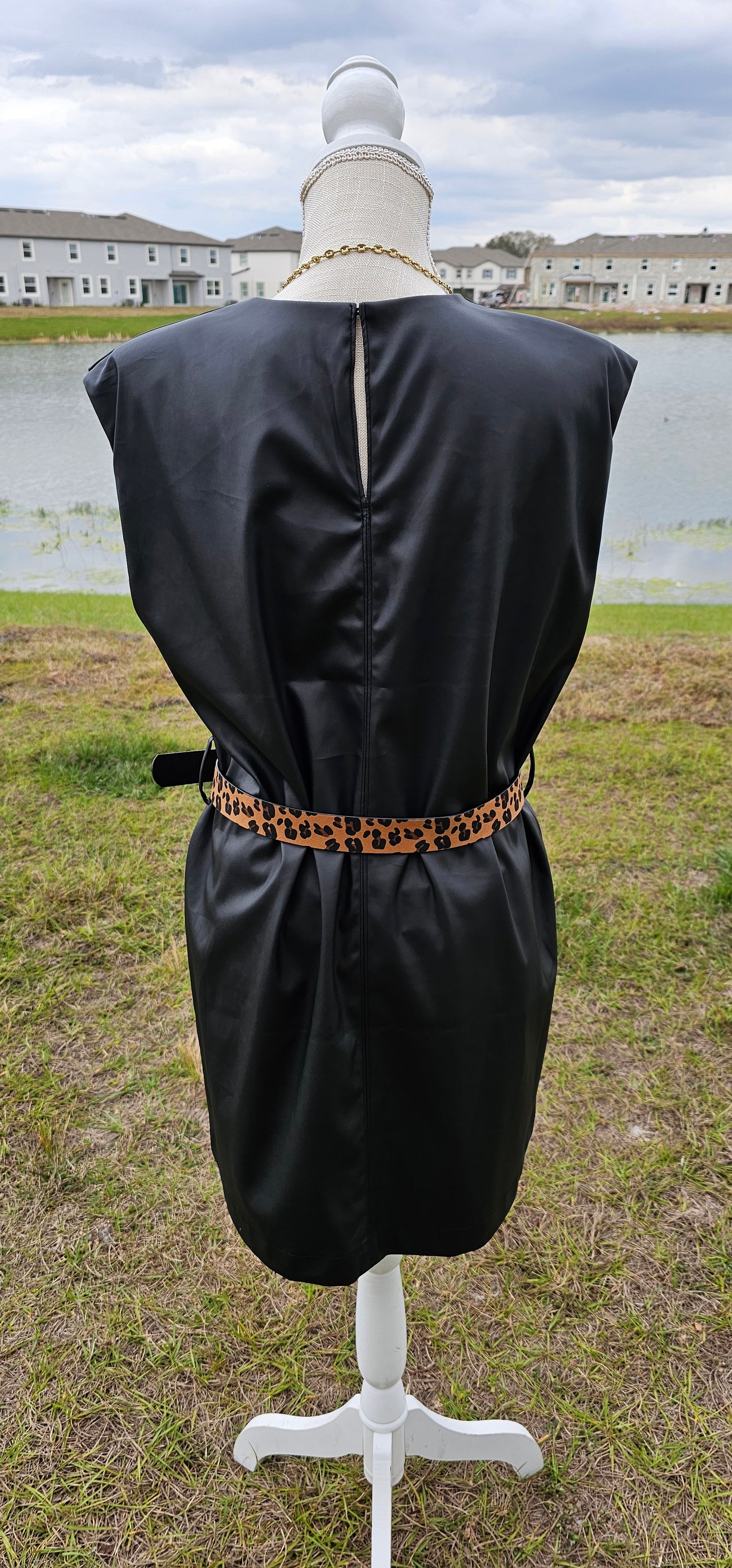 This vegan leather sleeveless dress offers shoulder pads, belt loops (belt not included), back opening with button closure, and is matte vegan leather. Go ahead and strut your stuff! It is great for a date, going to the office, or hanging out with the girls. Change the look of your dress by wearing different style belts. Sizes small through x-large.