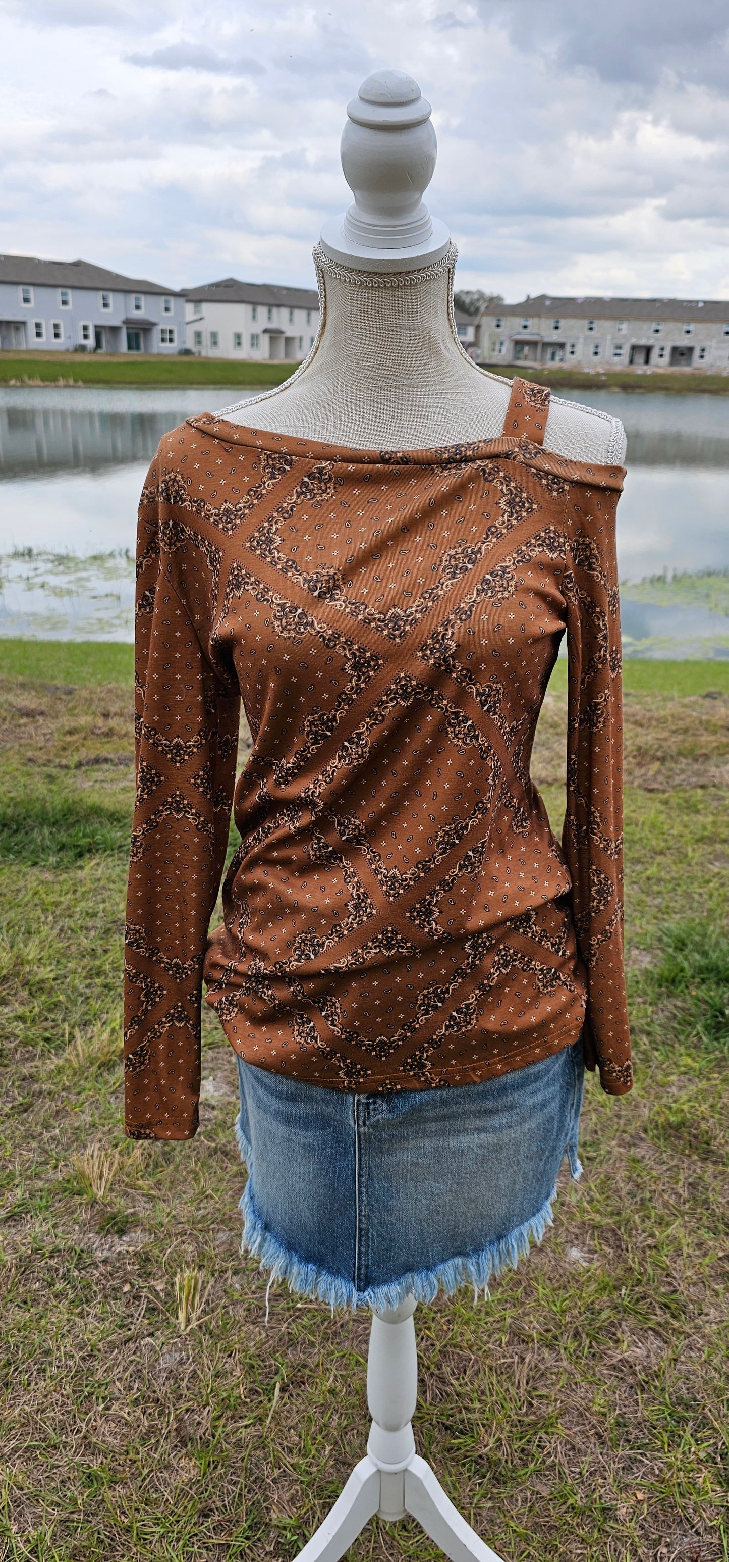 This top features one cold shoulder with strap, long sleeves, with bandana print. Light weight and breathable. Go ahead and wear it line dancing, to the rodeo, hanging out with your friends, or just running errands. You know that you want to give it a try! Sizes small through x-large.