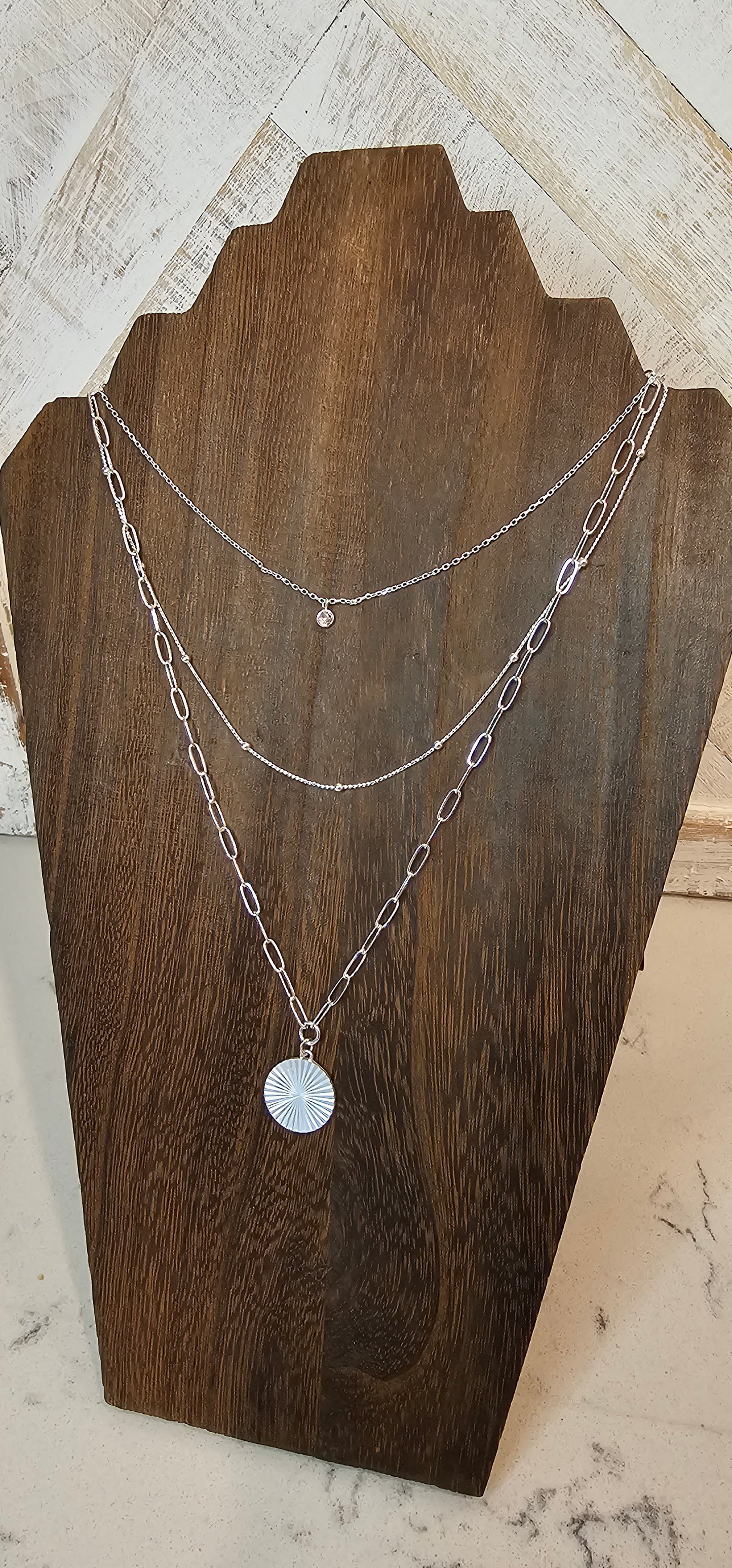 Approximate Length: Adjustable chain 16+2 inches Color: Silver link chains with circle pendant, silver beads, and small clear crystal Limited supply!