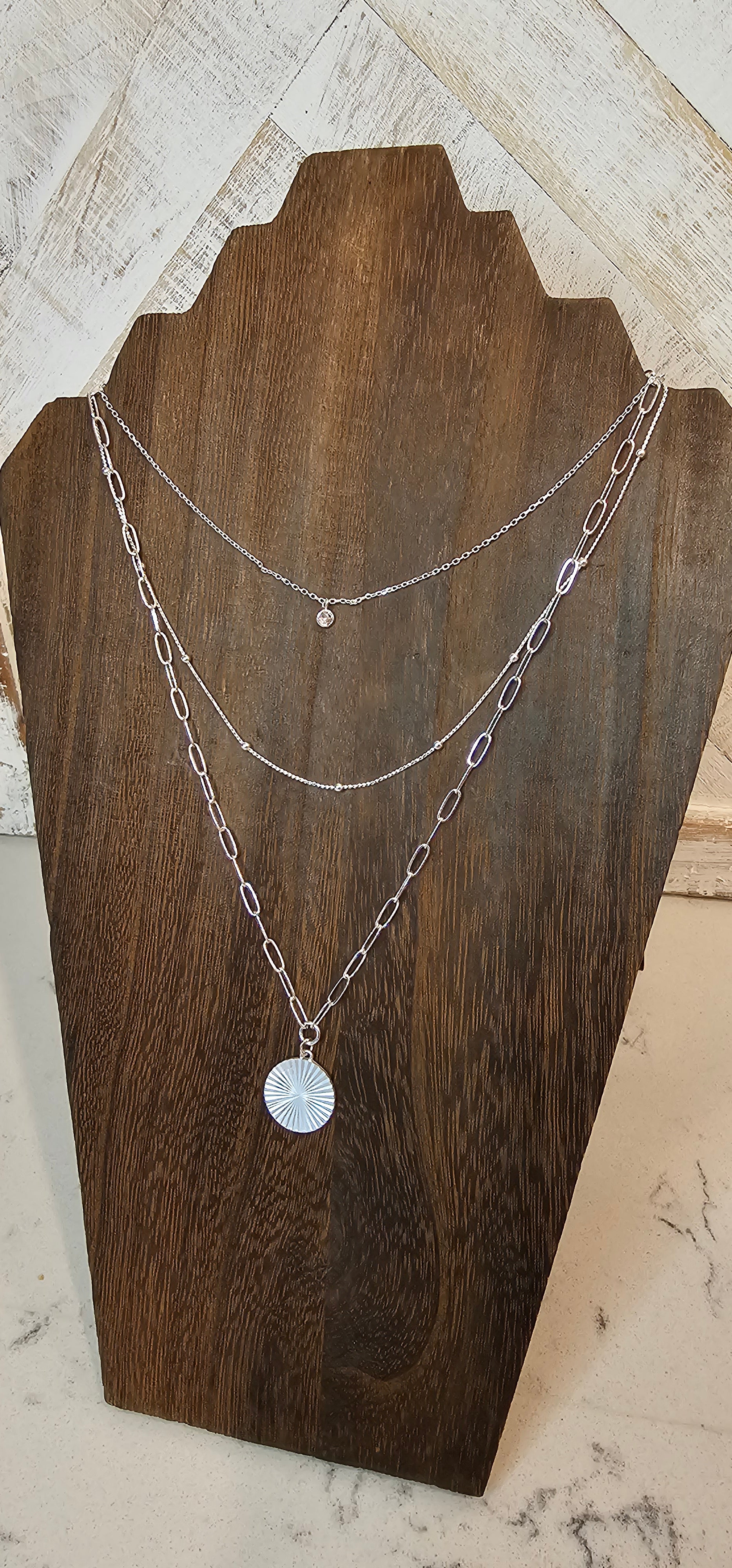 Approximate Length: Adjustable chain 16+2 inches Color: Silver link chains with circle pendant, silver beads, and small clear crystal Limited supply!