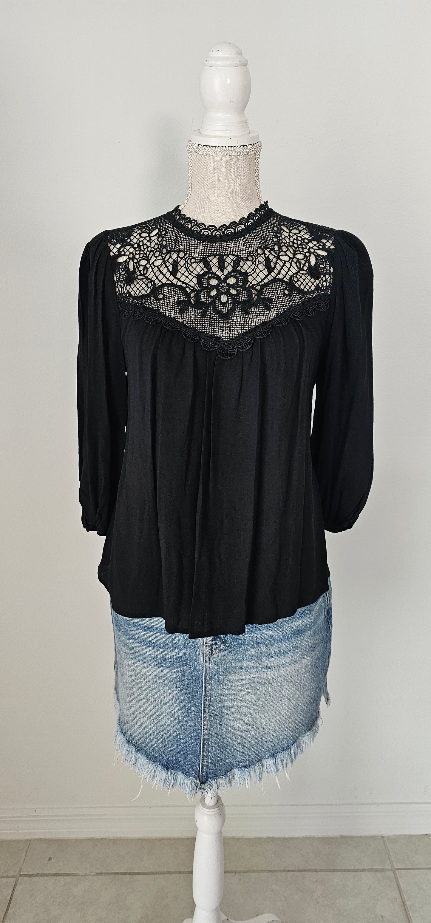 Rock your look with this ravishing top that'll take your fashion to the next level! With its elegant lace mock neck, stylish back-button closure with keyhole, and oh-so-pretty front lace inset and pleated bubble sleeves, you'll be sure to draw admiring glances wherever you go. Let's get fabulous! Sizes small through large.