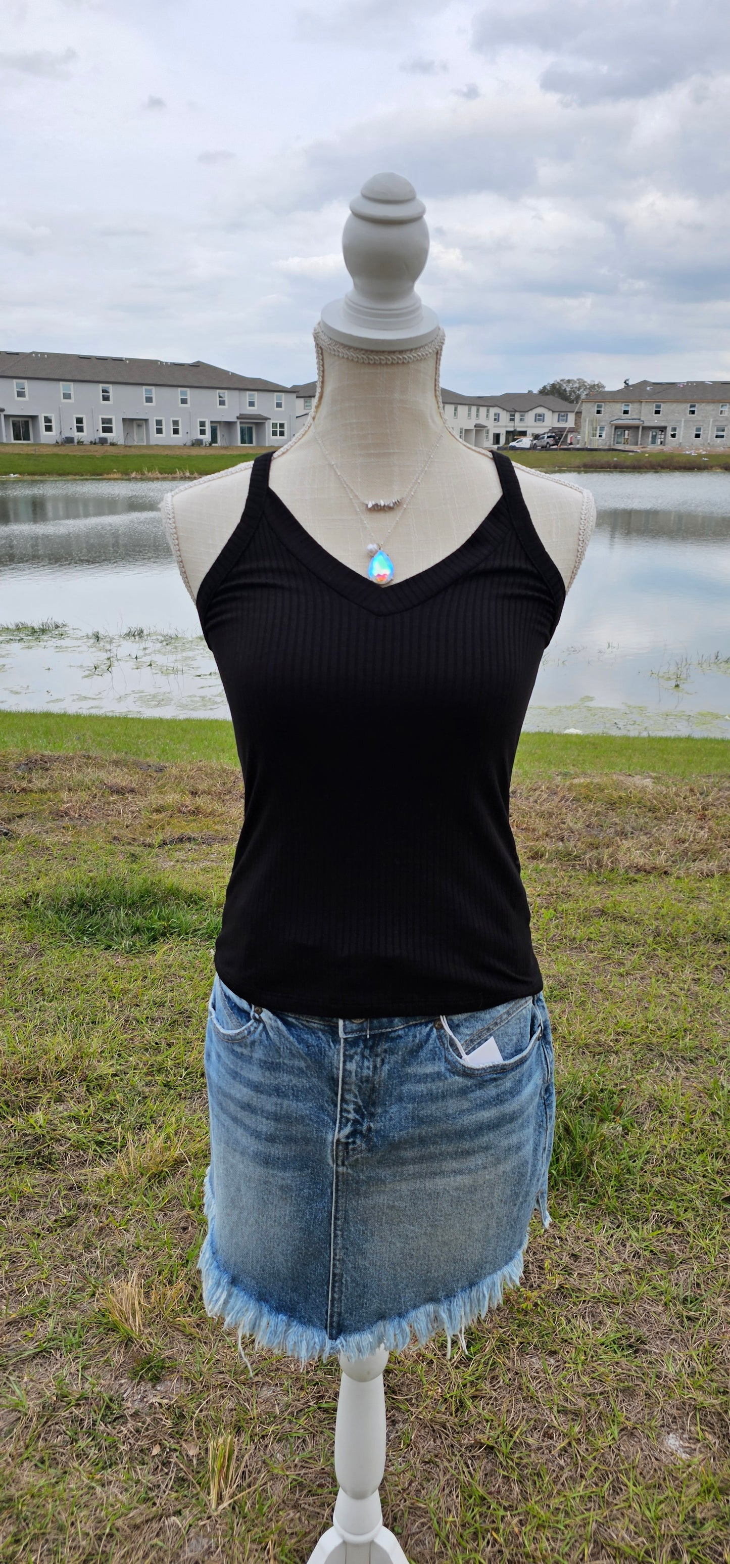 This “Basic Babe Tank Top: Black” features a ribbed fabric, sleeveless tank top with v-neck and back. This is a great basic staple piece! Sizes small through x-large.
