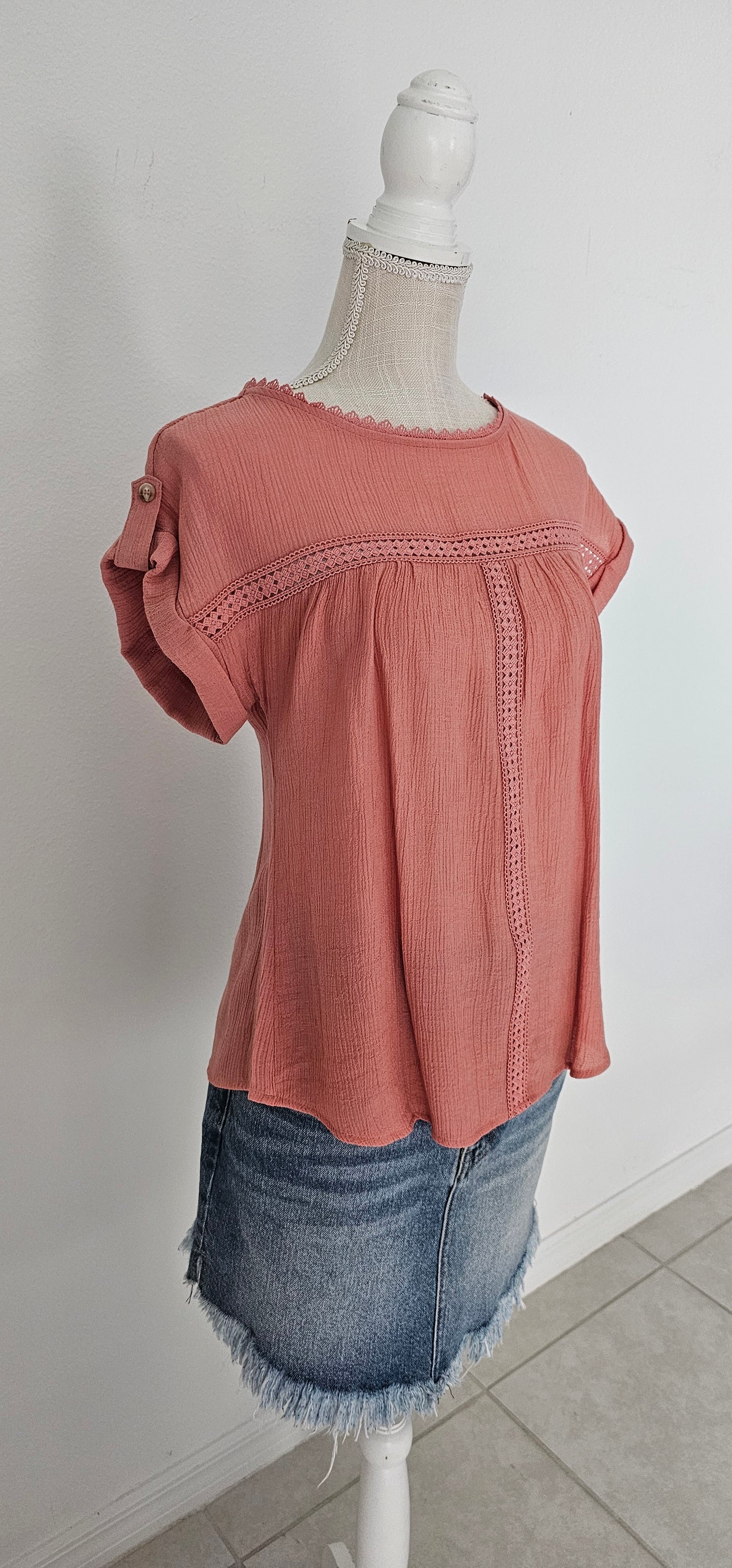 Add a touch of whimsy to your wardrobe with our "Paradise Dusty Apricot" lace top! Featuring round neck and classic lace trim, plus a button tab sleeve and short sleeve, you'll feel like you're in a floral-filled wonderland. (Oh yeah!) So, bring on the romance! Sizes small through large.