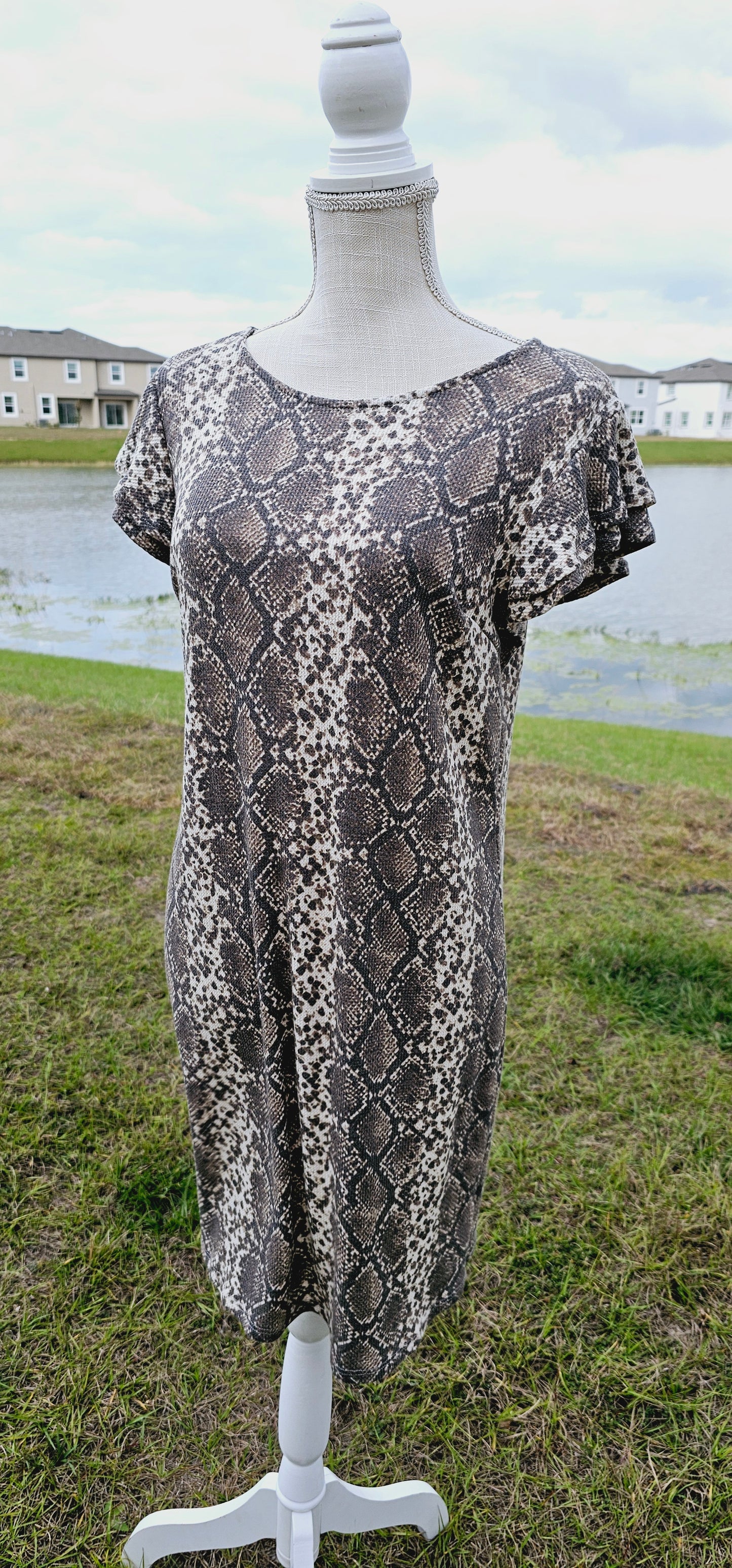 “Live In The Moment” is a snake print, waffle knit dress featuring ruffled layer sleeves, rounded neckline, and it sits above the knees. It is a soft, breathable material. This is unlined, non-sheer, and lightweight. This dress is cream and various browns. Sizes small through large.