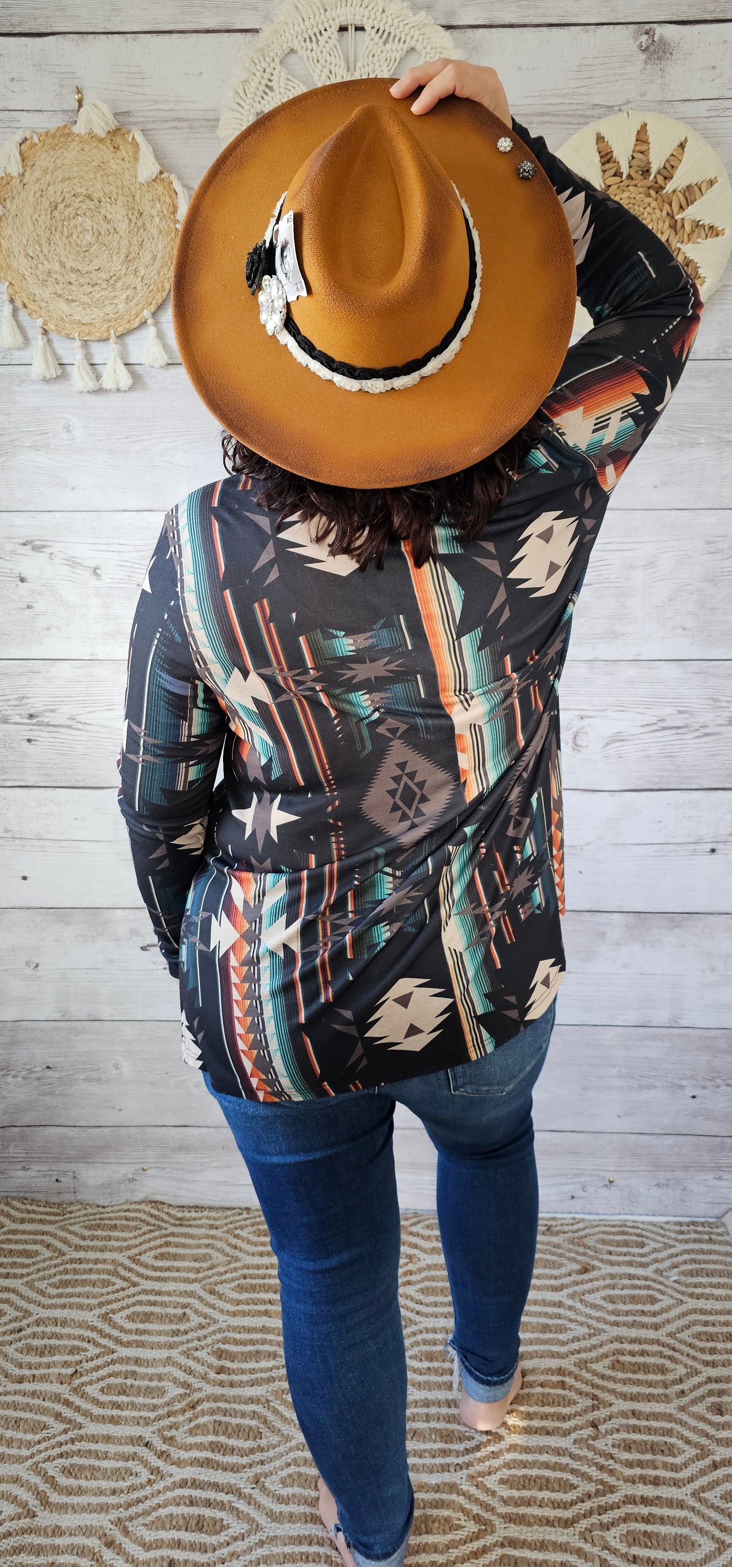 This is a comfy and casual long sleeve top. It features a rounded neckline with a V shaped cutout, long sleeves, Aztec design. Imagine yourself going to the rodeo, or line dancing. Whatever your adventure is, this is the shirt! Sizes small through x-large.