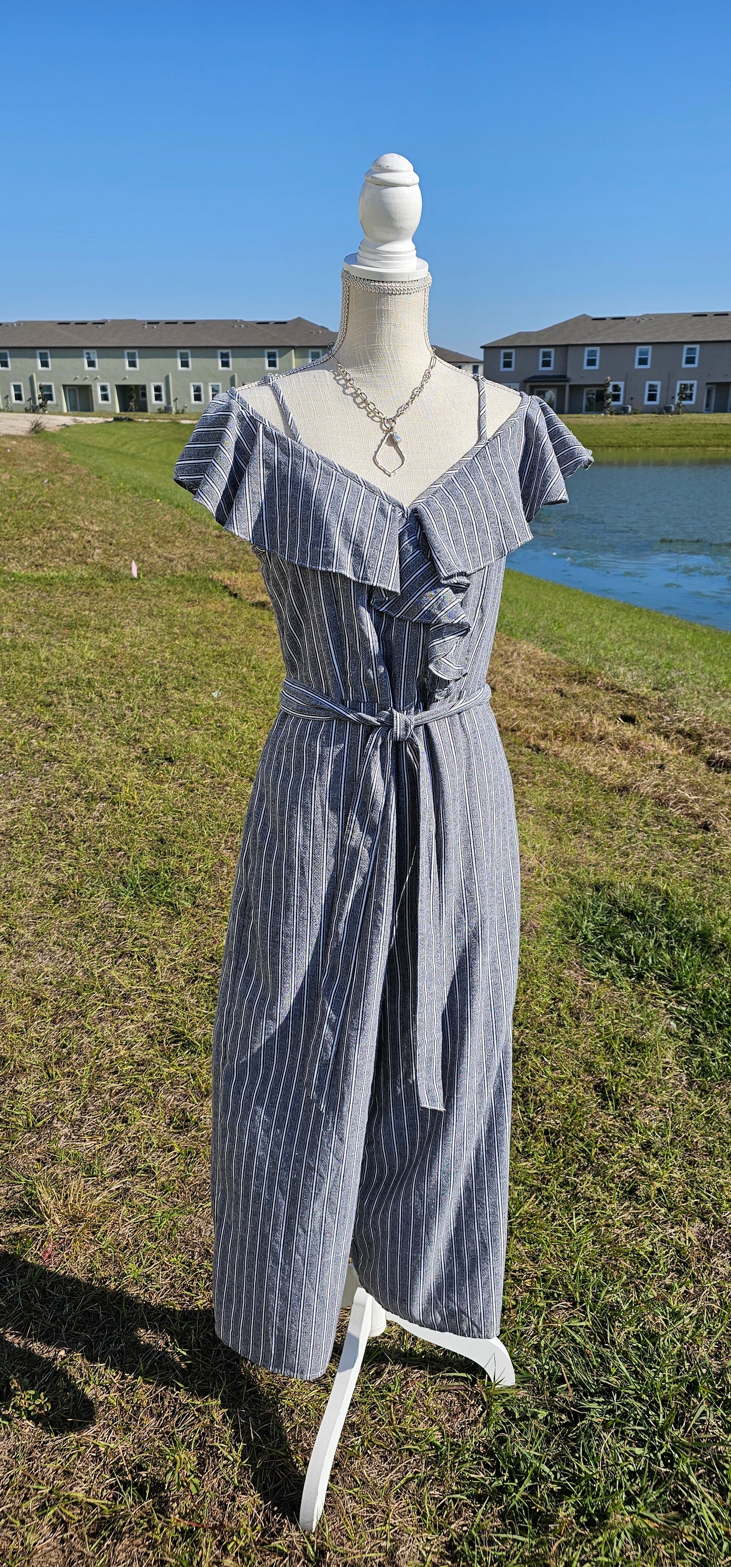 How adorable is the “Cool Breeze” jumpsuit. This jumpsuit features spaghetti straps that are adjustable, ruffled cold shoulder sleeves, ruffles down front in shape of a v, material tie belt for around waist, wide cropped legs, the pants have pockets, zipper and eyelet hook in back, and has gray, white, and black stripes. Just slip it on and you are ready for the day! I hear that a vacation is planned. What a great item to pack in your suitcase. Sizes small through large.