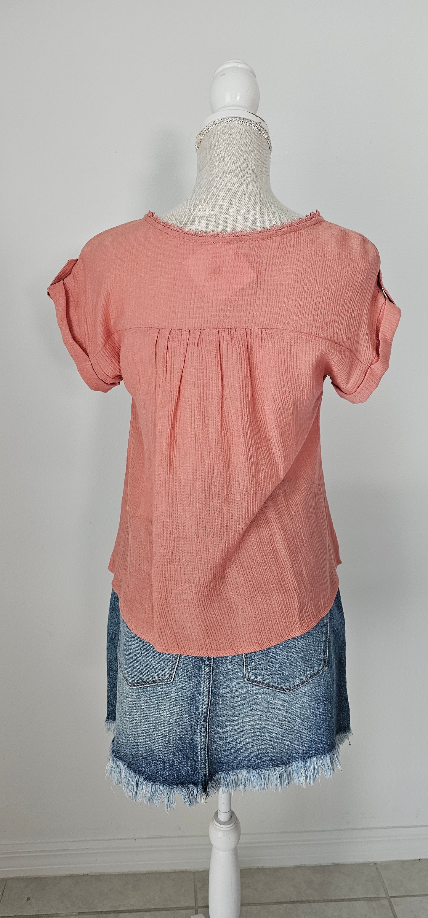 Add a touch of whimsy to your wardrobe with our "Paradise Dusty Apricot" lace top! Featuring round neck and classic lace trim, plus a button tab sleeve and short sleeve, you'll feel like you're in a floral-filled wonderland. (Oh yeah!) So, bring on the romance! Sizes small through large.