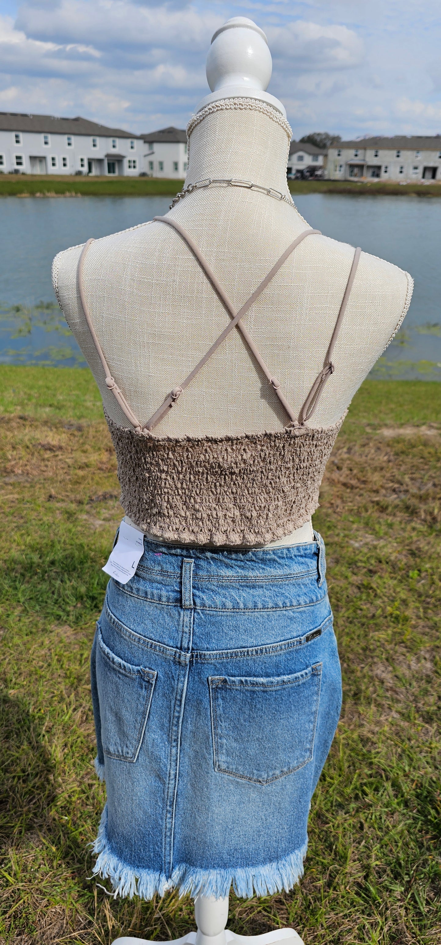 This bralette is a must have staple piece! It is easy for layering or great all by itself! This bralette is super comfy and can easily replace your current bra. No need to worry about clasps, this bralette easily slips over your head. It also features a floral crochet lace, ruched stretchy back, four adjustable straps with crisscross detail in back, and removable bra pads. Color is light mocha. Pair with your favorite jacket or off the shoulder sweater. Sizes small through x-large.