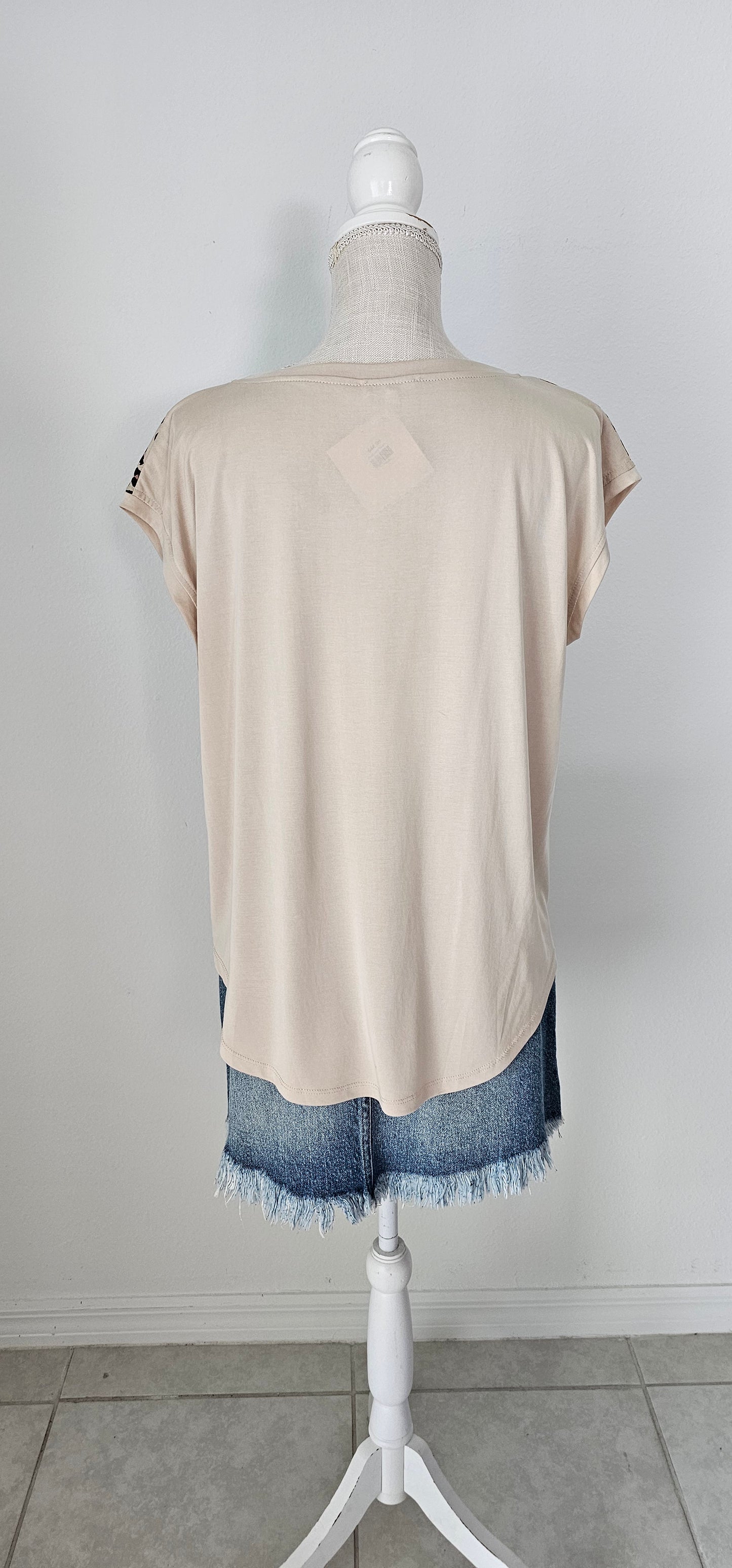 “Road Less Traveled” is a sleeveless top, with leopard print front (beige, brown, camel, agreeable gray) and contrast back, boat neckline, trimmed with beige soft modal, and rounded hemline. This is a satiny, silky soft high-low top. This is definitely a business or casual top. Sizes small through large.