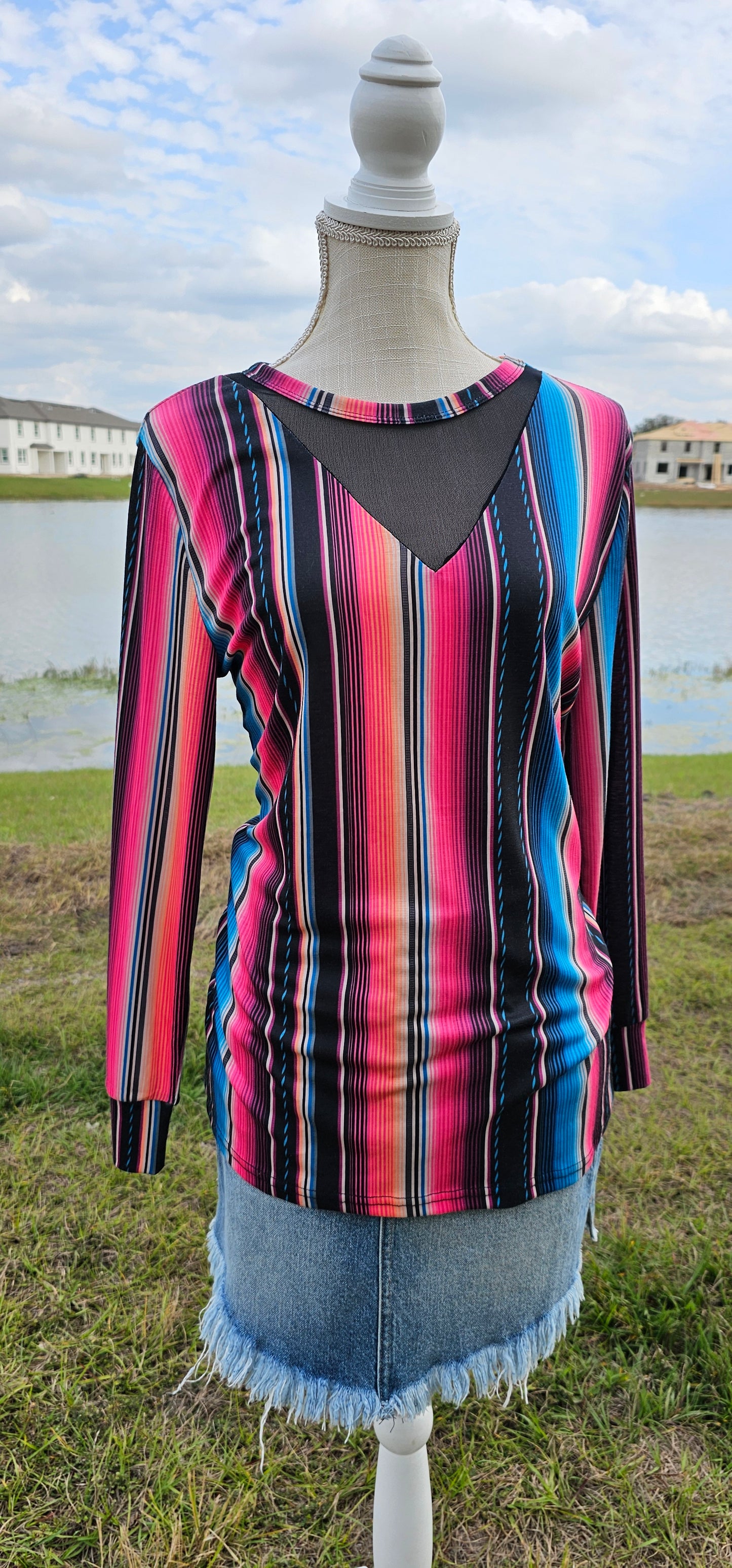 Imagine yourself in this long sleeve bright colored top that has a black mesh V cut-out. The sleeves offer a cuff for that nice fit. The bright colors really make this top pop. Going to the rodeo, line dancing, hanging out with family and friends, or just because, this top will be a great addition to your wardrobe. Sizes small through x-large.
